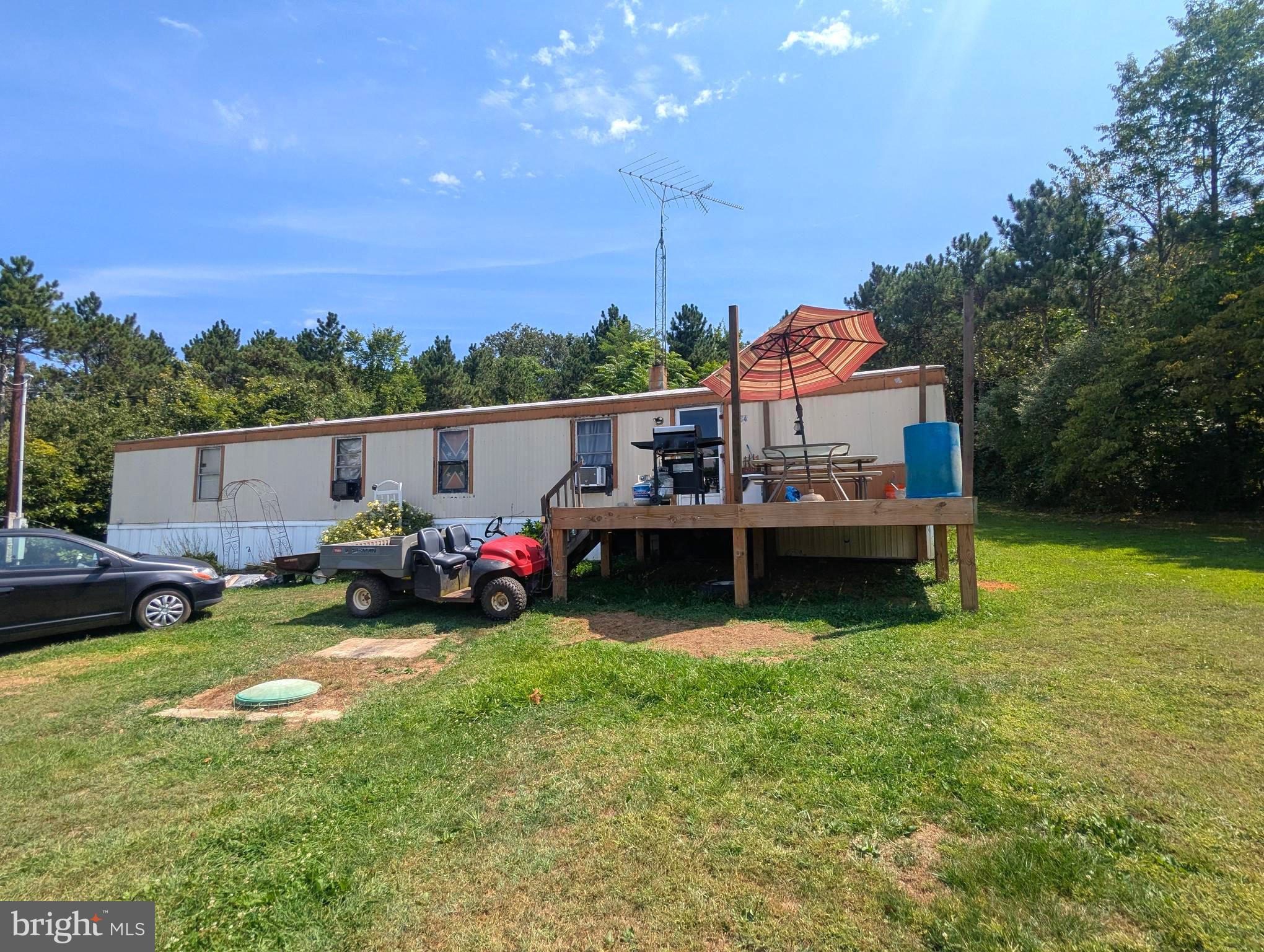 2 Acres with mobile home and plenty of storage sheds to make your own.  Home does need some repairs.
