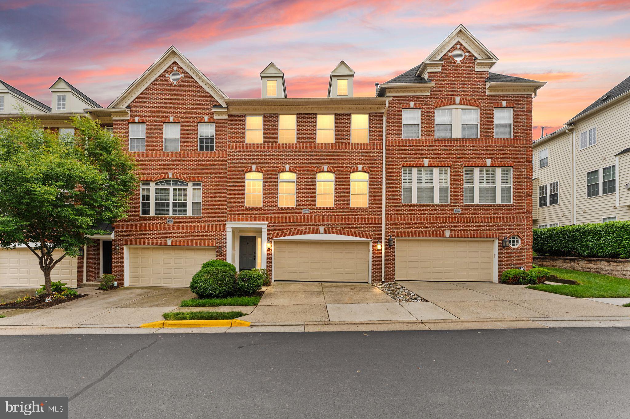 Welcome to this beautifully maintained three-level brick-front townhome condominium featuring a two-car front-loading garage and an open, light-filled floor plan.

The entry level offers a spacious family room, a convenient half bath, and direct access to the two-car front-loading garage—ideal for a home office, recreation room, or additional living space.

The second level is the heart of the home, featuring hardwood floors throughout and an open-concept layout designed for both everyday living and entertaining. The gourmet kitchen boasts white cabinetry, granite countertops, stainless steel appliances, and a sunny eat-in area. A separate dining room with crown molding and chair rail adds an elegant touch for formal gatherings. Just off the kitchen, the dramatic two-story family room is filled with natural light and opens to a private deck, perfect for outdoor dining or relaxing. The spacious primary suite is also located on this level and includes a custom walk-in closet and a luxurious ensuite bath with dual vanities, a soaking tub, and a separate shower.

The upper level features a versatile loft area overlooking the family room below, along with two additional bedrooms, a full hall bath, and a conveniently located laundry room.

Located in the highly sought-after Lowes Island community and part of Cascade, residents enjoy access to five swimming pools, numerous parks, tennis courts, and close proximity to Algonkian Regional Park. With easy access to Route 7 and Route 28, this exceptional home offers the perfect combination of comfort, style, and convenience.
