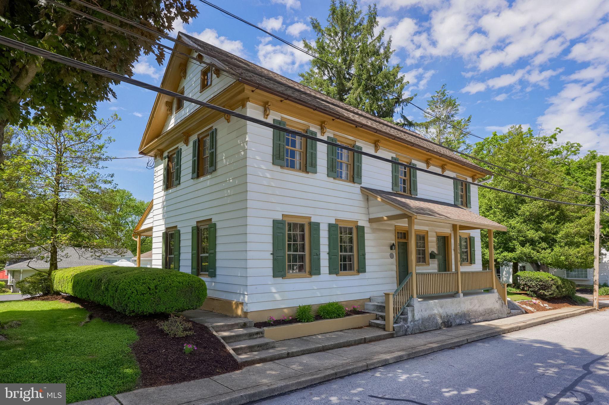 Step back in time at 326 Miller Street in the heart of historic Strasburg—a thoughtfully preserved and updated 18th-century colonial home dating back to 1753. Situated on a beautifully landscaped corner lot in the Lampeter-Strasburg School District, this one-of-a-kind property blends timeless character with everyday functionality. Inside, you’ll find remarkable period details including exposed hand-hewn beams, wide plank floors, original colonial hardware, chair rails, 1770s built-in corner cupboard, and a stunning walk-in fireplace complete with original crane and stone trim. The home offers flexible living spaces with multiple bedrooms, an office or nursery option, large storage areas, and a full walk-up attic. Outside, enjoy the detached oversized 2-car garage with additional upper storage, expansive turnaround driveway, raised garden beds, and brick patio perfect for relaxing or entertaining. Rich in documented local history tied to early Strasburg and colonial Pennsylvania, this home offers a rare opportunity to own a true piece of Lancaster County heritage while still enjoying modern comforts!