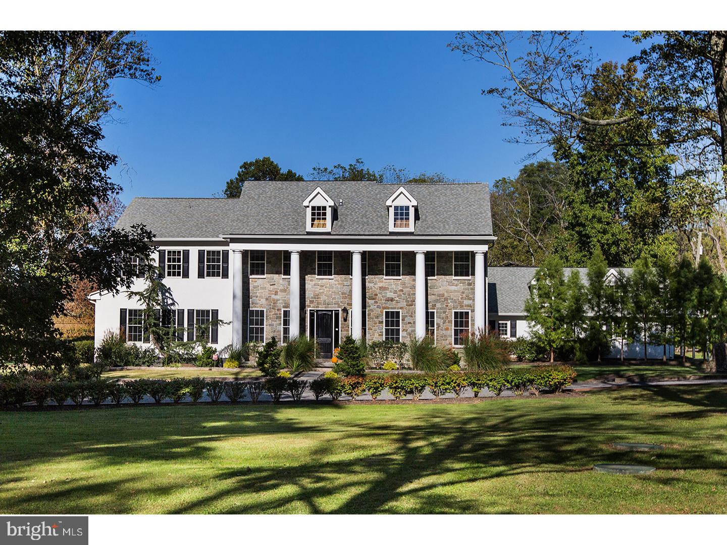 Set on over 12 acres of lush, park-like grounds and overlooking a serene pond, this extraordinary estate offers rare privacy and refined living. Backing to hundreds of protected, deed-restricted acres, the setting is both peaceful and picturesque.

The main residence seamlessly blends old-world character with today’s finest materials and modern conveniences. Original architectural elements have been thoughtfully repurposed throughout, honoring the home’s history while enhancing its eco-conscious design. Much of the wood used in the interiors was reclaimed from the original homestead and is believed to pre-date Columbus, adding a sense of timeless authenticity to the space.

The open and flexible floor plan is ideal for modern living, with hand-hewn wood details and radiant floor heating throughout the first level. The sun-drenched interiors are framed by expansive windows offering uninterrupted, private views of the surrounding landscape. At the heart of the home is a state-of-the-art chef’s kitchen with top-of-the-line appliances, designed for both everyday cooking and elegant entertaining.

The main house features six en suite bedrooms, indoor and outdoor fireplaces, a fully integrated smart home system, and a private home theatre. A charming columned front porch adds to the home’s classic appeal.

An attached wing offers its own separate kitchen, living/dining area, laundry room, three bedrooms, and two full baths—perfect for extended family, guests, or staff quarters, and can be closed off for privacy if desired. Additionally, a beautifully restored antique guest cottage offers further flexibility and charm.

A separate barn-style building provides exceptional space for a car collection, gym, or large-scale storage, while a three-car garage is conveniently connected to the main house via a covered breezeway.

The outdoor living spaces are equally impressive, featuring a covered terrace with an outdoor fireplace and multiple seating and dining areas. These overlook the beautifully designed heated saltwater pool. Ample parking and dual access from front and rear driveways make entertaining effortless.

Located in desirable New Hope-Solebury, just 70 minutes to New York City, one hour to Philadelphia, and 35 minutes to Princeton.