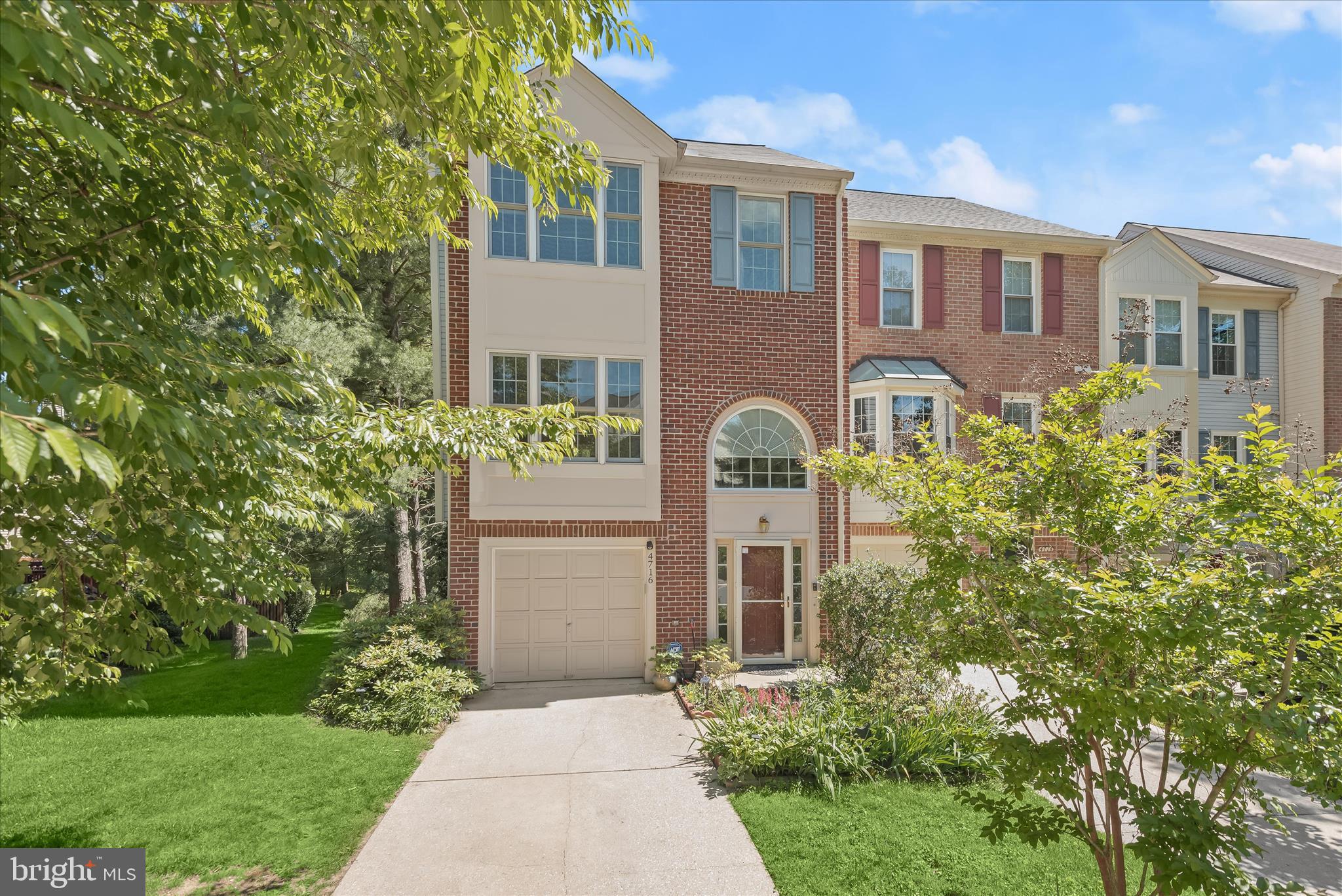 Spacious end-of-row townhome in a sought-after Ellicott City community offering an exceptional blend of comfort, style, and convenience. The attractive brick-front exterior welcomes you into a thoughtfully designed floor plan. The entry level features a spacious walkout family room, a full bathroom, and convenient access to the attached 2-car garage, perfect for flexible living, guests, or a home office.
The sun-filled main level boasts an open-concept layout enhanced by hardwood flooring and charming bay window bump-outs in the living and dining areas. The well-appointed kitchen offers rich wood cabinetry, quartz countertops, stainless steel appliances, and a bright breakfast room with access to the expansive deck overlooking a privacy-fenced yard backing to woods, creating an ideal setting for outdoor dining, entertaining, or simply enjoying the peaceful surroundings. Upstairs, the primary suite impresses with a soaring vaulted ceiling and a private en suite bathroom. Two additional bedrooms, a full hall bath, and a convenient laundry room complete the upper level.  Ideally located near major commuter routes, shopping, dining, and entertainment, this beautifully maintained home offers the space, functionality, and location today's buyers are seeking. Enjoy the rare combination of a premium end-unit location, wooded backdrop, private outdoor living space, and versatile floor plan in one exceptional home.