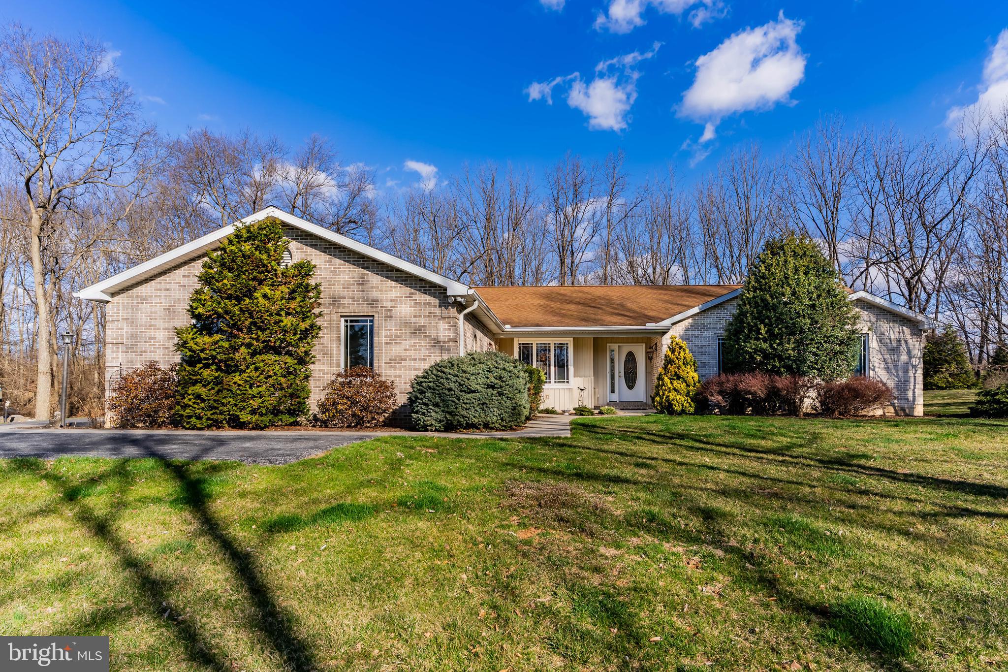 **Charming Ranch Home in Serene Country Subdivision** Welcome to your dream retreat! Nestled on a peaceful cul-de-sac in Greystone Acres, West Pennsboro Township,  this stunning ranch home offers the perfect blend of modern comfort and country charm on an expansive 2.11 acre lot. With three spacious bedrooms and two and a half baths, this home is sure to be the one you're looking for! Step inside to discover a beautifully designed open-concept layout that seamlessly connects the living spaces, bathed in plenty of natural light. The heart of the home is undoubtedly the exquisite kitchen, featuring rich hickory cabinets and solid countertops that provide both style and functionality. A generous pantry ensures you have all the storage space you need for your culinary adventures.  The kitchen is open to the cozy family room with its propane stove to enjoy on chilly winter evenings.  Enjoy year-round comfort in the delightful four-season room—ideal for sipping morning coffee or unwinding with a good book as you take in views of your fenced rear yard. Step outside onto your large covered composite deck—perfect for entertaining guests or simply enjoying quiet moments surrounded by nature. Additional features include convenient main-level laundry facilities, a dedicated office space located on the lower level for remote work or study, and even a canning kitchen—ideal for preserving those homegrown delights from your own garden! This property truly embodies modern, single level country living at its finest. Don’t miss out on this rare opportunity to own such an exceptional home where tranquility meets sophistication. **Schedule your private tour today! This gem won’t last long—experience firsthand all that this beautiful ranch home has to offer!**