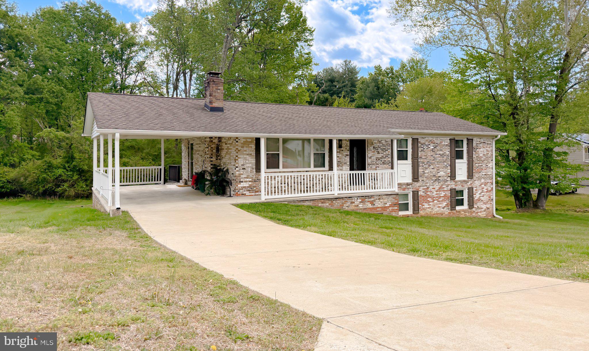 This charming ranch-style home in Singing Hills offers a perfect blend of comfort and modern living. With four spacious bedrooms and three full bathrooms, the open floor plan invites natural light throughout. The heart of the home features a beautifully updated kitchen with an island and stainless steel appliances, ideal for gatherings. Relax in the cozy living room by the brick fireplace or unwind in the luxurious jetted tub. Step outside to enjoy the expansive 1.15-acre lot, backing to serene trees, providing a peaceful retreat. The outdoor space includes a deck and patio, perfect for entertaining or enjoying quiet evenings. The fully finished basement adds versatility, whether for recreation or additional storage. Thoughtful updates & improvements mean this home is in good condition, ready for you to move in. With ample parking, including a concrete driveway and attached carport, convenience is at your fingertips. Experience the warmth and charm of this inviting home, where every detail has been thoughtfully designed for your comfort. See it for yourself today! Rural Development Eligible for Qualified Buyers