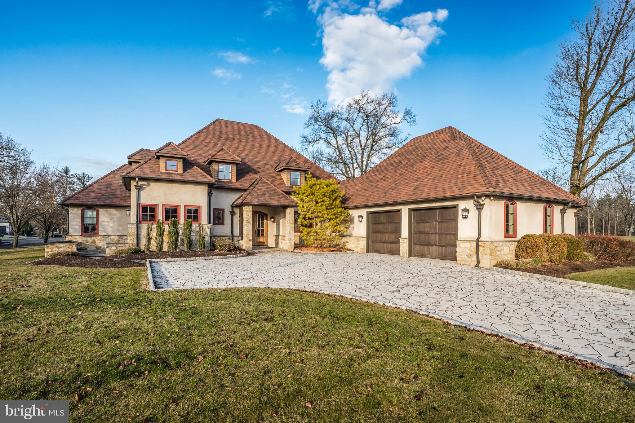 Located within the exclusive Epernay community adjacent to Saucon Valley Country Club, this elegant French Provincial home offers refined finishes, thoughtful design, effortless living and a premier setting in Upper Saucon Township. This custom residence features a classic stucco & stone exterior and charming architectural details throughout. The arched double front door opens to a Turkish Calacatta marble foyer and bright open living spaces with bamboo hardwood floors, gas fireplace and French doors to flagstone patios. The gourmet kitchen features Italian Marble countertops, custom cabinets, 60" Wolf gas range & double oven, Sub-Zero professional refrigerator, large island with seating for 4, Wolfe professional warming drawer and a window-wrapped breakfast nook to enjoy the beautiful views of Epernay. The 1st floor primary suite features a fully custom walk-in closet outfitted w/ adjustable rods and shelves & a 3-piece full length mirror, and en suite bath with separate vanities, custom makeup table, tile shower, soaking tub & private water closet. Each bathroom and laundry have been customized w/ hand picked tile & countertops, and custom cabinets lending to the true elegance and thoughtful design of the property. Additional features include a 2nd floor lounge with built-in Sub-Zero beverage center, solid hardwood interior doors, radiant heated floors, copper downspouts and gutters, and outdoor spaces finished in flagstone, stonework and outfitted with a fire pit gas line.