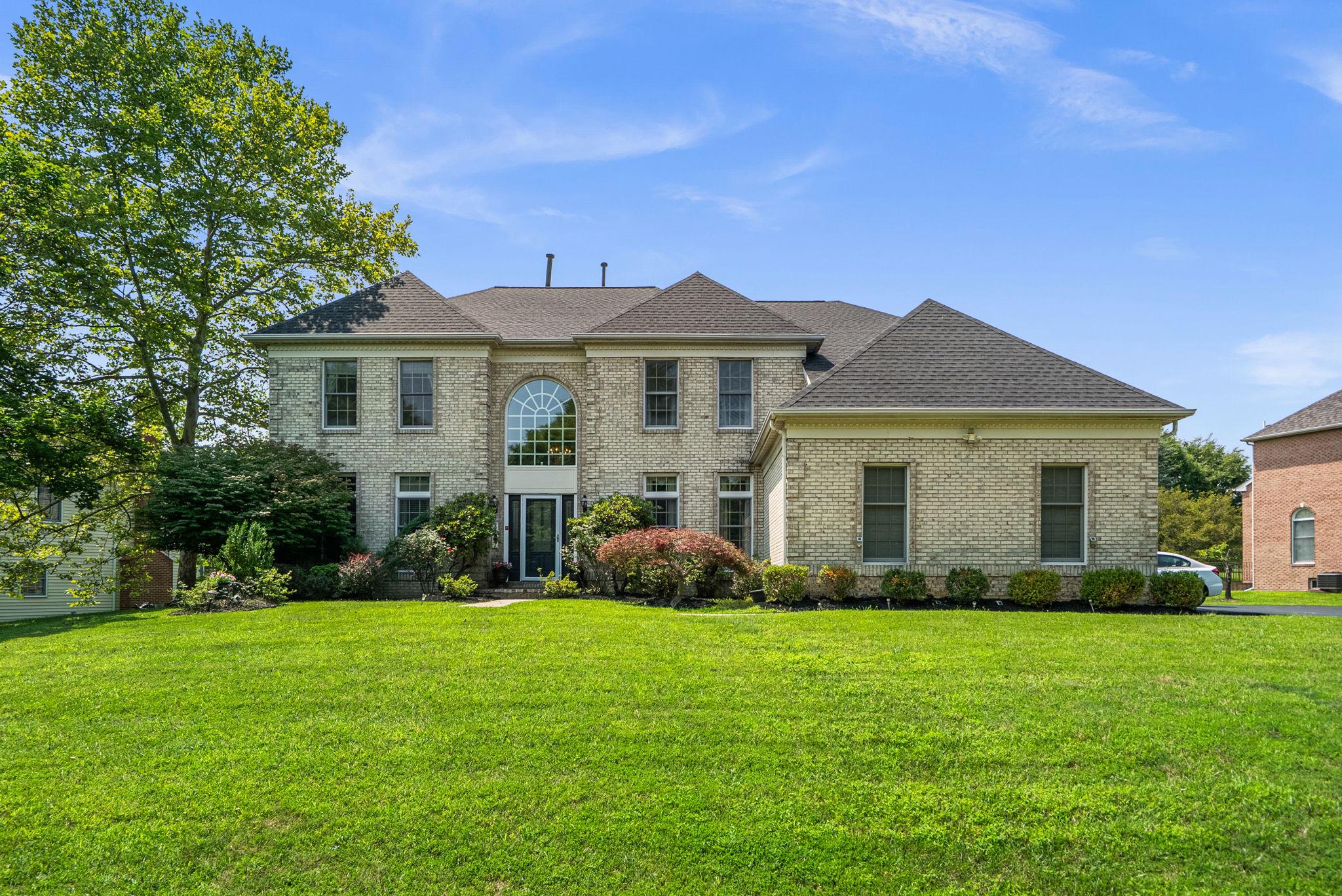 Welcome to this stunning four-bedroom brick estate, perfectly situated on one of the most picturesque lots in the highly sought-after Brooke Manor community. Nestled on a beautifully landscaped 0.57-acre homesite, this exceptional property offers the perfect balance of privacy and convenience. Ideally located just minutes from Route 200 (ICC), Georgia Avenue, and Route 28, it is a commuter's dream—yet tucked away within the neighborhood, providing a peaceful setting free from road noise. 

Designed with both everyday living and hosting in mind, the main level features an open, airy floor plan. The expansive gourmet kitchen boasts crisp white cabinetry, newer stainless steel appliances, a large center island, and abundant natural light from oversized windows, skylights, and French doors leading to the deck and patio.

The kitchen opens to the spectacular two-story family room, where soaring ceilings, dramatic Palladian windows, walls of glass, a floor-to-ceiling brick fireplace, and a secondary staircase create an unforgettable gathering space. French doors provide seamless indoor-outdoor living, while a convenient powder room and laundry room complete the main level.

Upstairs, plush neutral carpeting enhances the comfort of three generously sized secondary bedrooms and the luxurious primary suite. The spacious owner's retreat features double-door entry, a sitting area, walk-in closets, and a well-appointed en-suite bath. One secondary bedroom enjoys its own private en-suite bath, while the remaining two bedrooms share a convenient Jack-and-Jill bath.

The fully finished lower level expands the home's living space with a large recreation room, wet bar, media room, private den or office, and a full bath—offering endless possibilities for entertaining, relaxing, or accommodating guests.

Outdoor living is equally impressive. Step through the French doors from either the kitchen or family room onto the expansive deck with low-maintenance vinyl railings, which overlooks a large stone patio and tranquil backyard. The beautifully landscaped setting provides the perfect backdrop for peaceful mornings with coffee, outdoor dining, and memorable gatherings with family and friends.

Beyond the home, you'll appreciate the outstanding location. Residents of Brooke Manor enjoy exceptional community amenities, including an outdoor swimming pool, tennis courts, tot lots, and scenic walking paths, creating an active and welcoming neighborhood lifestyle. The community is also conveniently located near premier private schools, including Our Lady of Good Counsel High School, as well as a large indoor aquatic center just across Georgia Avenue. Enjoy easy access to grocery stores, shopping, restaurants, parks, and everyday conveniences, along with the renowned Olney Theatre Center and the many amenities that make this area such a desirable place to call home.

Offering timeless elegance, thoughtful updates, and exceptional living spaces, this remarkable Brooke Manor residence combines a brand-new roof, fresh interior paint, beautifully refinished hardwood floors, and an unbeatable blend of privacy, convenience, and location. This is a rare opportunity to own a truly move-in-ready home in one of the area's most desirable communities.