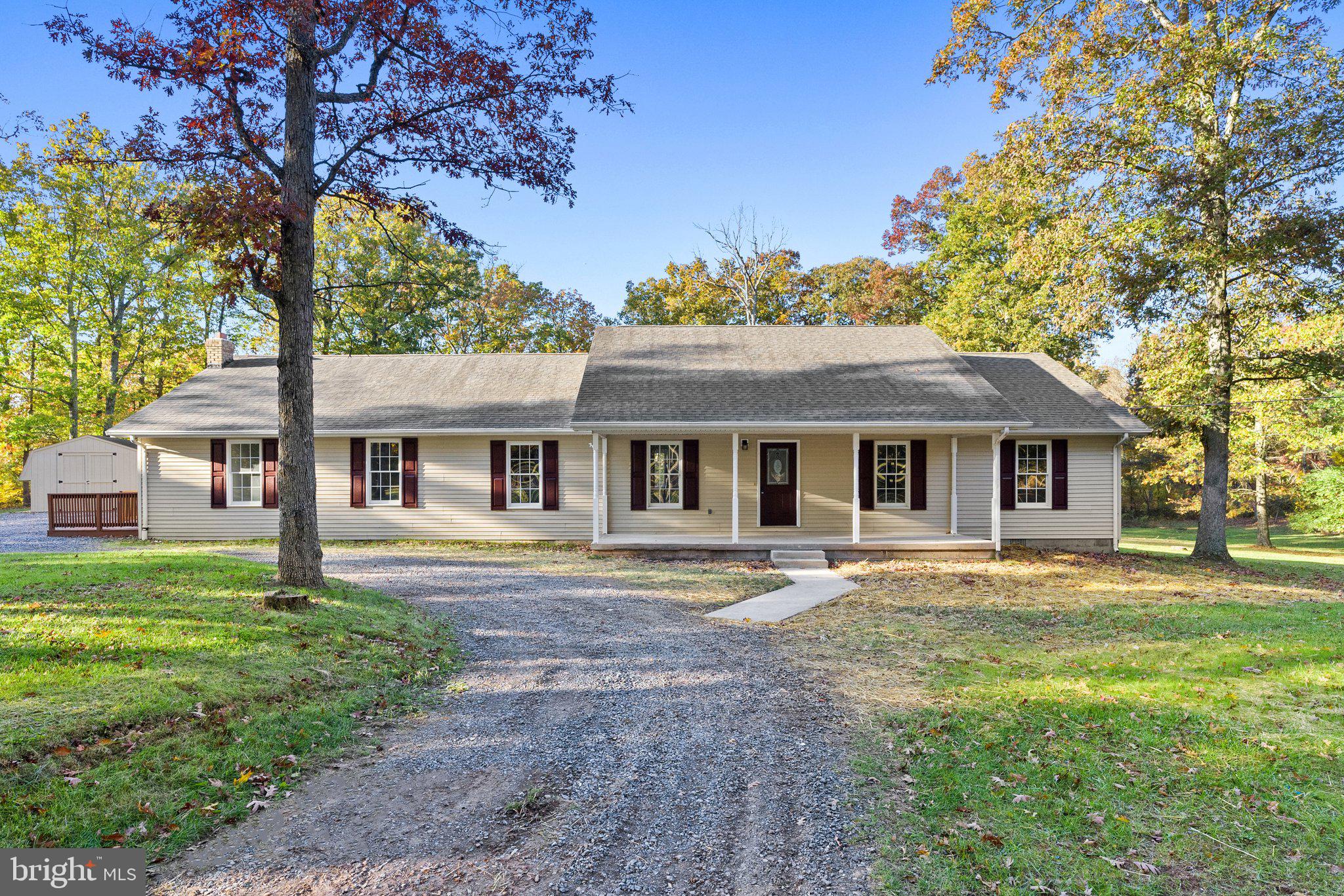 Surrounded by farmland, this 2,364 sq. ft. rancher sits on a stunning 2.5-acre lot under mature hardwoods, giving you privacy and nature views. With four bedrooms and 2.5 baths, this renovated home is airy, open and inviting. A modern layout with luxury vinyl plank flooring and light paint provides a blank canvas for you to make this home your own. A welcoming living space with a fireplace tucked in the corner is adjacent to both a dining area and kitchen featuring contemporary grey cabinetry, lots of counter space and new appliances. The owner’s suite provides ample room and closet space with a generous en suite bath that segues into a dually accessible laundry area. Sit on your roomy front porch or back deck to enjoy the views and solitude, and use the additional storage shed for whatever you want. Key improvements include a new: roof, HVAC system, flooring, multiple kitchen and bathroom elements, paint, deck stain, ceiling fans, and lighting, plus other improvements and maintenance, making this house like new!  A short drive to Winchester for shopping, restaurants and more.  Only 30 miles to Winchester Medical Center!