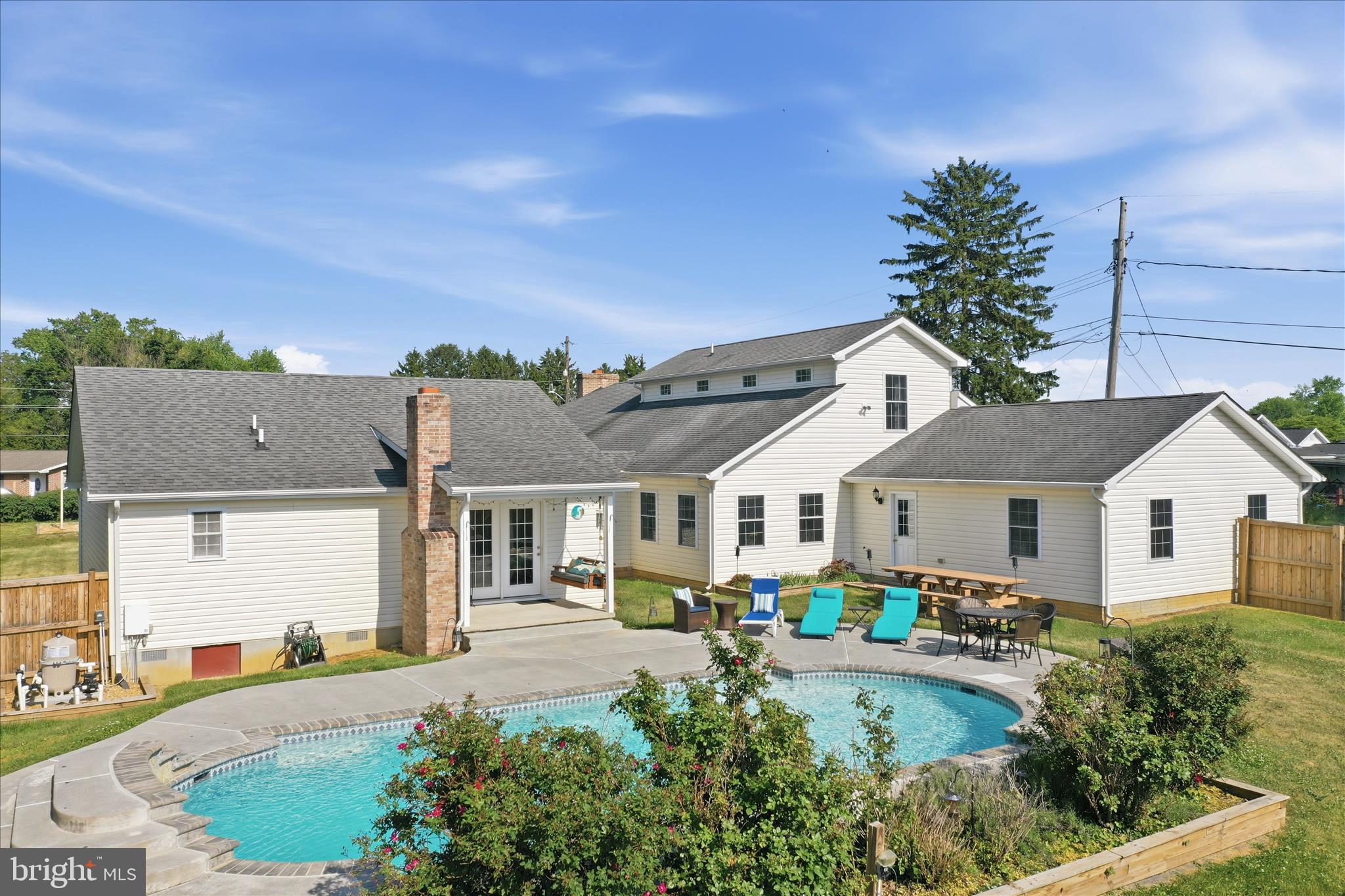 Spacious, one-of-a-kind property offering over 4,000 finished sq ft on a rare double lot in Charles Town! This 7 bedroom, 5 full bathroom home combines space, flexibility, and functionality with a layout ideal for multi-generational living, large households, or anyone needing room to spread out. The original home was fully renovated in 2000/2001 with additional expansions completed in 2009 and 2013. Features include an in-ground saltwater pool, fenced front and rear yards, privacy fencing in the backyard, garden shed, and multiple outdoor entertaining areas. Inside, the home offers oversized living spaces, a spacious primary suite, and a versatile floor plan with mostly one-level living plus an additional upper-level suite. Major system  include 3 HVAC systems, dual heating options with heat pump and oil/hot water backup heat for added efficiency and comfort during colder months, plus updated roof sections corresponding with the additions. No HOA and county location provide added flexibility while still being conveniently located near shopping, dining, commuter routes, and downtown Charles Town. A truly unique opportunity with space, versatility, and features rarely found in one property.