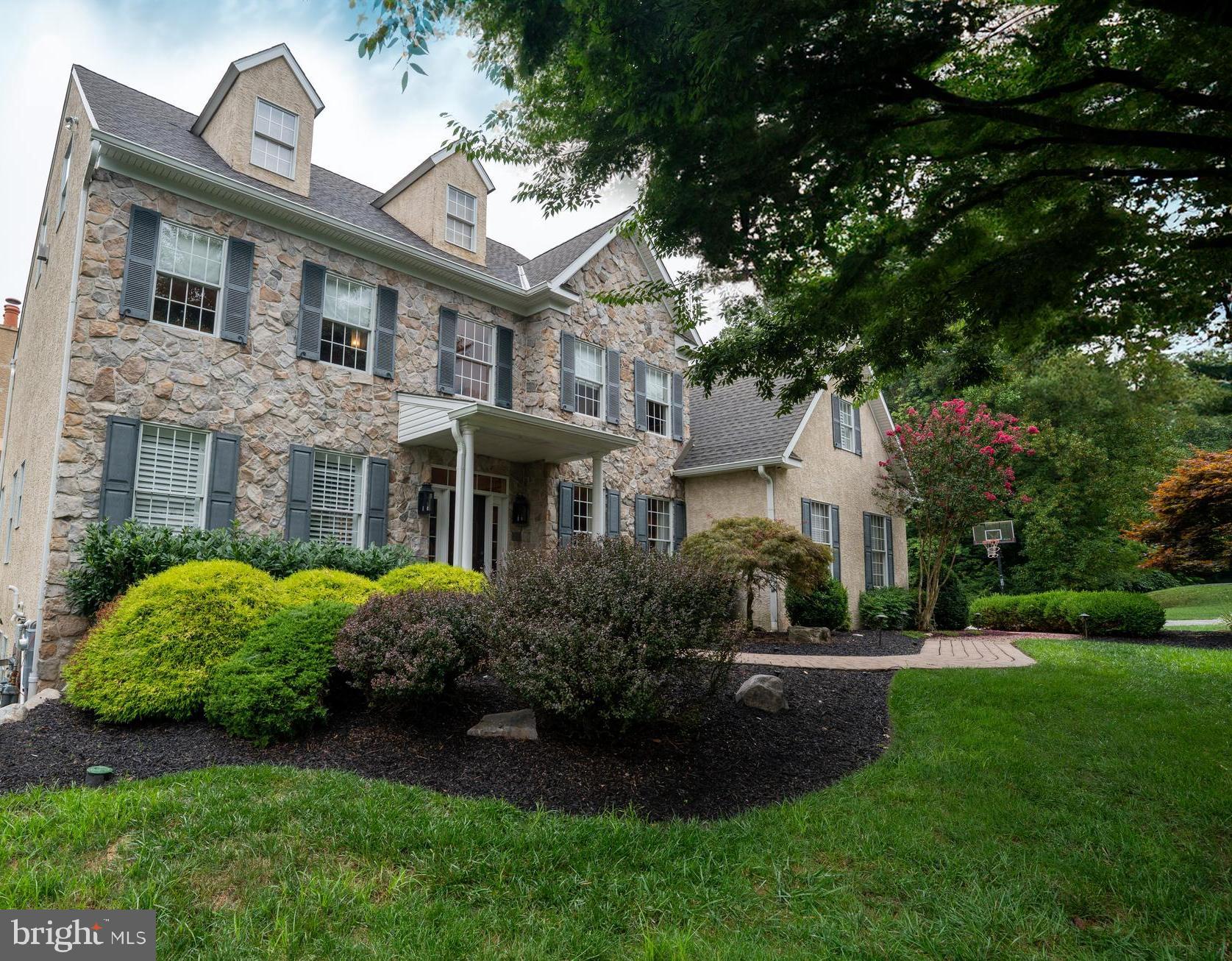 Welcome to 2312 Holly Lane, Lafayette Hill – a refined, elegant residence that combines sophistication with luxurious living. The unique interior layout features 6 bedrooms, 4.5 bathrooms, and 4 finished floors.

Entering the main floor, you are greeted by a bright, open-concept space filled with natural light. A gourmet kitchen features pristine granite countertops with an island, hand-blown glass lighting, custom cabinets, a large pantry, and high ceilings. An adjacent breakfast area with vaulted ceilings provides an airy and relaxing atmosphere. Beside the kitchen, there is an elevated deck and dedicated grilling area with a scenic view.

Centrally situated, the formal living room is highlighted by 20-foot ceilings and a grand, stone mantle fireplace. This inviting space opens to a bright sunroom with panoramic views and a gas fireplace. Interchangeable window panels and radiant heated floors allow for year-round enjoyment. Adjacent to the living room is a cozy den, perfect for family gatherings and movie nights.

The formal dining room, adorned with crown molding, offers an elegant setting for entertaining guests. Glass French doors lead to a library that provides a quiet, tranquil workspace. The laundry room, situated next to the garage and mudroom, adds to the home’s practicality. Throughout the main floor, the solid hardwood flooring adds a touch of warmth and sophistication.

Ascending to the second floor, you will find the main bedroom with an en-suite bathroom, a true retreat. It features quartzite countertops, high-end fixtures, an extra-large soaking tub, a large walk-in shower, custom built-in drawers and cabinets, and individual his and hers closets. The additional three bedrooms on this floor are equally impressive, with two full bathrooms, ensuring comfort and convenience for all.

This one-of-a-kind home features a fully finished attic and basement. An open staircase leads to the attic, where you will find a large bonus room ready for your entertainment needs. This large living space has multiple storage spaces, making it a versatile area for various needs. The walk-out basement is a haven of entertainment, fitness, and relaxation. It features a large living room with a fireplace and flat-screen television equipped with surround sound speakers. Two additional bedrooms, a full bath, a gym with mirrors, and a large cedar sauna provide additional amenities. A modern bar complete with a wine refrigerator and a beverage refrigerator is perfect for entertaining guests. French doors lead to a covered patio with a stunning travertine pool area and spa. Connecting to the pool area is an additional hard-scaped terrace with a waterfall and koi pond, creating a serene outdoor oasis.

The exterior of the home adds to its allure. The two-car garage and large driveway provide ample parking space. The yard, equipped with an irrigation system in both the front and back, ensures lush and well-maintained landscaping.

Offering an unmatched level of luxury, this property in Lafayette Hill is a rare find for those seeking both sophistication and comfort.