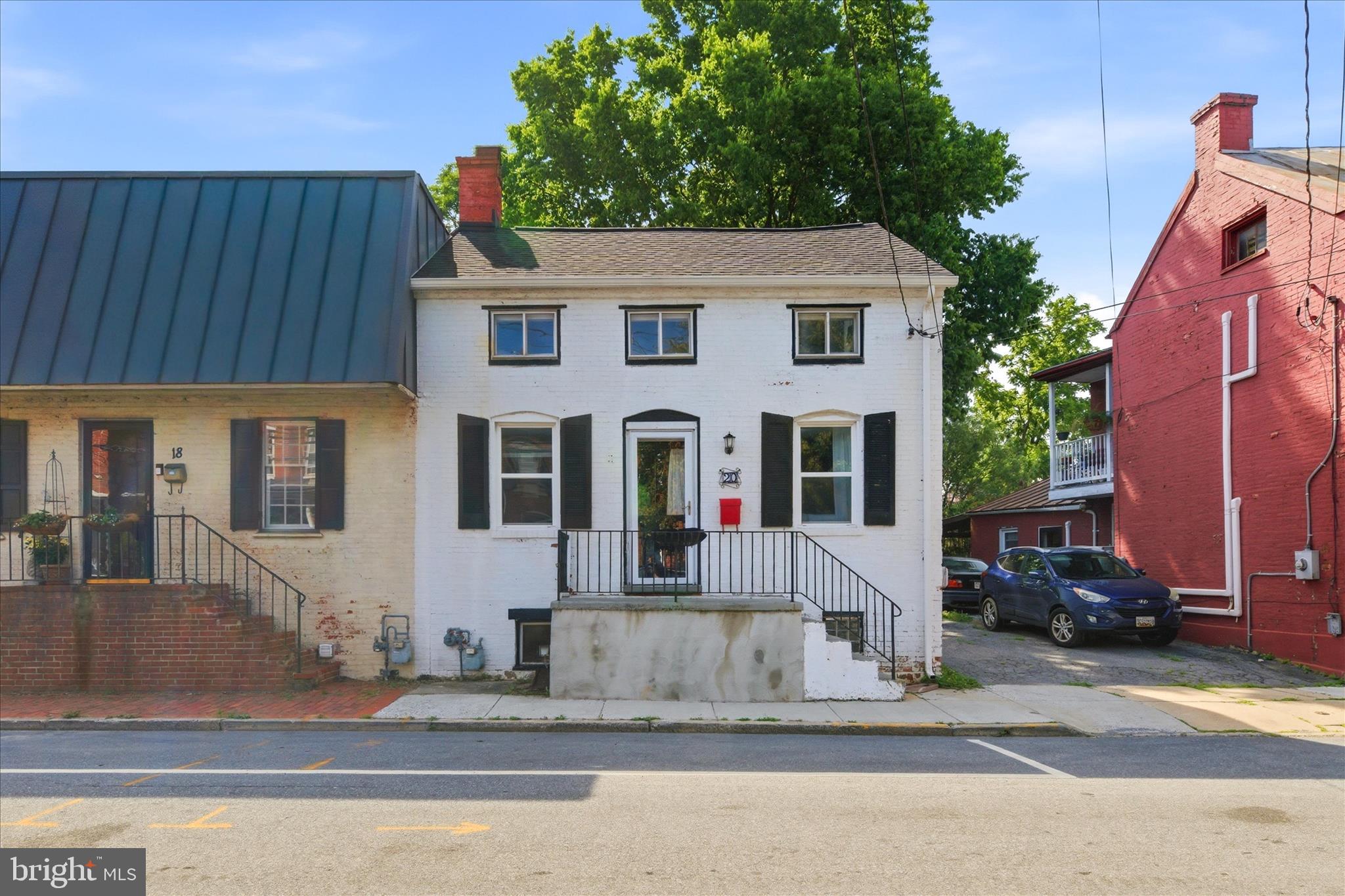 Welcome to this charming brick row home in the heart of Downtown Frederick, offering over 1,100 square feet of character and modern updates! A two bedroom at this price is an exceptional opportunity for first timers, downsizers and investors alike. Original exposed ceiling beams and a vaulted eat-in kitchen with white cabinets and butcher-block counters give this home a warm, cottage-like feel. There is a main-level primary bedroom suite with claw foot tub, pedestal sink, which is exceptionally rare for downtown Frederick. Washer and dryer in the enclosed porch, conveniently not in the basement. The spacious upper-level loft bedroom offers endless possibilities for a second bedroom, home office, or creative space. Major systems have all been recently updated to include newer architectural shingle roof,  mini-split heating and cooling system, hot water heater, all updated in the last four to five years, giving buyers true peace of mind on an older home. Enjoy a large rear yard for entertaining which is exceptionally deep. Off-street parking in the driveway, storage shed, and a recently re-built front stoop. All of this just a short walk to Baker Park, Carroll Creek and everything Downtown Frederick has to offer. Don't miss this one!