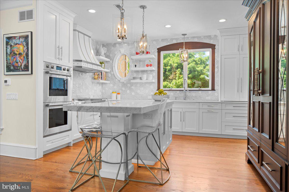 Tucked away at the end of a private flag lot cul-de-sac in Kingswood Ridge — one of the closest luxury neighborhoods to downtown New Hope — this exceptional Solebury residence offers the rare combination of privacy, scale, and walkability to the area’s renowned restaurants, galleries, and shops. Set amidst beautifully landscaped grounds with a resort-style pool and spa, the home is designed for both grand entertaining and comfortable everyday living.

A dramatic two-story foyer opens to soaring living and dining rooms filled with natural light and architectural volume. At the heart of the home is a beautifully updated kitchen featuring stunning Carrera marble mosaic backsplash details, dual built-in full-size Sub-Zero refrigerators, an additional full-size SUBZERO freezer in the pantry, and an adjoining laundry/mudroom. A dual-sided fireplace connects the formal living room with the expansive eat-in kitchen, while a spectacular sunroom overlooks the private backyard oasis complete with an inground pool, spa, Trex-style decking, extensive landscape lighting, and mature plantings that create a true spa-like retreat. A beautifully constructed new pool cabana adds to the resort atmosphere and includes a changing room and full bath for effortless indoor-outdoor entertaining.

The first-floor primary suite occupies its own private wing and features vaulted ceilings, a fireplace, sitting room, multiple walk-in closets, and an oversized bath with dramatic scale and natural light. Upstairs are three additional en suite bedrooms, each offering privacy and generous proportions, along with a massive bonus room above the garage with its own half bath — ideal as a media room, gym, office, playroom, or additional guest space.

The walkout lower level offers exceptional flexibility with a private guest-suite-style apartment complete with its own living area, full kitchen, bedroom space, and sunroom. Altogether, the property offers 4 bedrooms and 6 full plus 2 half bathrooms spread throughout the main residence and pool cabana. Additional highlights include a three-car garage with enough height for vehicle lifts or stacked car storage, beautifully maintained grounds, and one of the most desirable locations in Solebury Township — moments from downtown New Hope while still offering the space, quiet, and privacy expected from a premier estate property.
