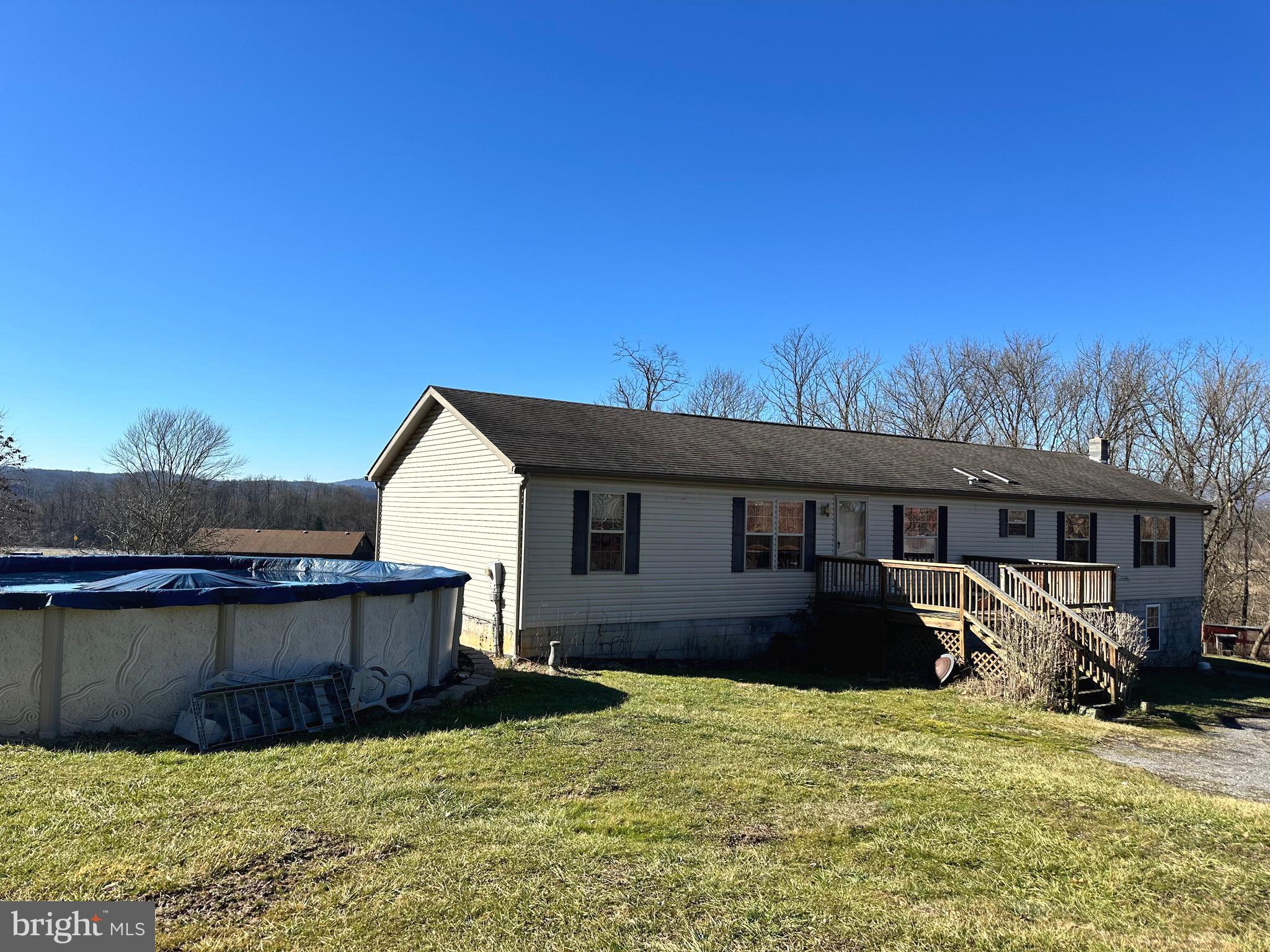 This 4-bedroom 2.5 bath home sits on one acre, outside city limits, and has everything you need. An above ground pool, a deck with beautiful views, a partially finished basement with rec room, storage and another possible bedroom and an open floor concept!  The house has a breakfast nook off the kitchen, 2 living rooms one with a wood fireplace, and a large dining room.  The master bedroom has a walk-in closet and a large master bath with tub and separate shower. There is main level laundry.