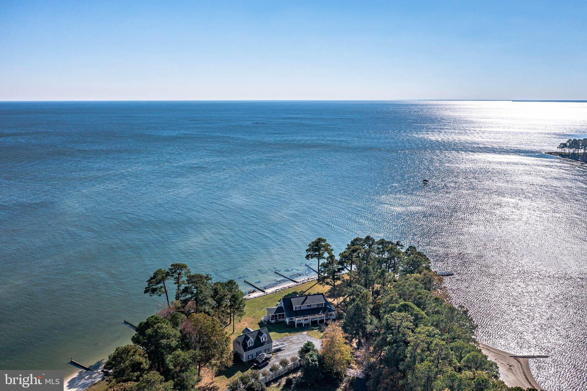 Welcome to luxury living at its very best! This incredibly private Northern Neck Retreat on the Chesapeake Bay & Taskmaker Creek is the perfect vacation get away, family compound or your dream forever home. The home can be purchased fully furnished, so you can start enjoying your new home from day one!!! This beautiful 4B/3.5B home will absolutely take your breath away with astounding water & wildlife views, a protected private sandy beach with a BRAND NEW pier + a covered boat/jet ski lift with shore power (water, electric & lighting).  Situated on more than 2 acres, this home offers abundant living & entertaining space indoors and out. For boating enthusiasts, there is a detached 2-car/boat garage with an additional private expansive space (could be used as a guest suite/office/playroom) with bay views. This property is the perfect escape from the hustle and bustle of the DC/Richmond Metro areas, even for a short weekend. The home is within 2.5 hours’ drive of DC and 1.5 hours from Richmond. 
Enjoy and watch the amazing diversity of wildlife: bald eagles, herons, swans and shoreline birds + abundant sea life. Swim or launch your kayak, paddle board from the concrete boat launch or your private sandy beach and head to the Creek and/or out into the Bay. Bring your jet skis or boat! 3 ft. MLW. On nice evenings year-round, finish the day sipping cocktails at the end of the NEW expansive Pier, enjoy endless water and wildlife views & the rhythmic sounds of gentle waves to lure you to sleep or just step down on your private beach and roast marshmallows around the fire pit. Either way, you’ll enjoy the most incredible Bay and Creek sunsets & sunrises. You can watch the 4th of July Reedville Fireworks from your pier/beach!
Meticulously maintained by the owners, this spacious home NNK Cape Cod home seamlessly flows for entertaining with a relaxed great room and dining area with walls of windows and French doors opening onto a stone patio that runs the length of the home and showcases unobstructed views of the Chesapeake Bay & Taskmaker Creek. 
Step out into your spacious private bayside screened porch to enjoy your morning coffee or relax in the evenings by watching the lights of the Smith Point Lighthouse and the giant cargo/cruise ships & sailboats illuminating their path through the Chesapeake Bay. 
The extraordinary features of this home make it ideal for entertaining, quiet family gatherings or a crowd. The home boasts 4 large bedrooms with the primary with an ensuite bath & an additional office/bedroom on the main level. Upstairs offers 3 additional bedrooms + 2 full baths on that level. One bedroom upstairs has an attached study/nursery. All rooms offer with Bay or Creek views. Main level laundry. NEW Whole-house backup generator & very large, detached storage shed with an outside rack for kayaks, paddleboards and sailboat space. 
Home CAN be purchased “TURN-KEY” fully furnished (except for family heirlooms), water toys (kayaks, paddle boards) & golf cart. All you need to bring is your bathing suit and toothbrush! More than $250k+ in Improvements & Upgrades: Complete interior painted 2026, New Whole House Generator 2025, New Refrigerator, Washer & Dishwasher 2025, Reconstructed/Restored Breakwaters/groins and Replace Pier 2024, Renovate interior of Boat House 2024, Moen Flo Smart Water Monitor 2024, Encapsulated crawl space with new humidifier. No HOA, private well and public sewer. No HOA. *There is an annual fee for road maintenance approximately $100 – 150 for all residents of Taskmaker Lane. Offering the perfect blend of comfort, style, and convenience, this home makes an excellent bayside home, or a perfect vacation rental too. Call today to set up your private showing! This beautiful property won't last! 
Please see agent’s notes in BrightMLS. Schedule showings online through ShowingTime or by calling the listing agent directly. Minimum 48 hour notice prefered