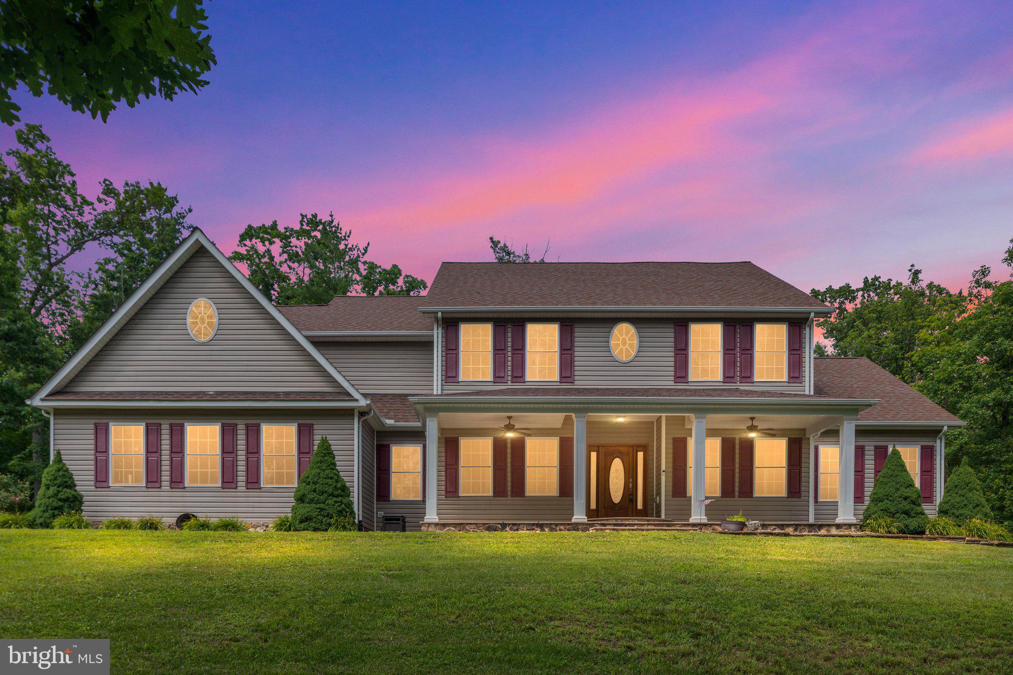 PRICED BELOW APPRAISED VALUE!! Nestled on an expansive 6.84-acre lot just minutes from shopping, dining, and commuter routes, this stunning colonial exudes elegance and comfort. Built in 2013, the home features a harmonious blend of vinyl siding and stone, creating a timeless façade that invites you in. Step inside to discover five spacious bedrooms and six bathrooms. The heart of the home boasts a cozy fireplace, perfect for intimate gatherings or quiet evenings. With the primary suite on the main level along with your laundry, the home proves to be extremely functional on all levels. A fully finished basement offers endless possibilities for entertainment or relaxation, with both interior access and an outside entrance for convenience. Grab a seat at the bar, pick your spot on the couch to watch TV, work out, or play games in the game room. Enjoy the serenity of your private retreat, complete with an attached side-entry garage and ample driveway space. This property is not just a home; it's a lifestyle, offering the perfect balance of sophistication and warmth. Experience the tranquility and exclusivity that this remarkable residence has to offer, where every detail has been crafted for your comfort and enjoyment.