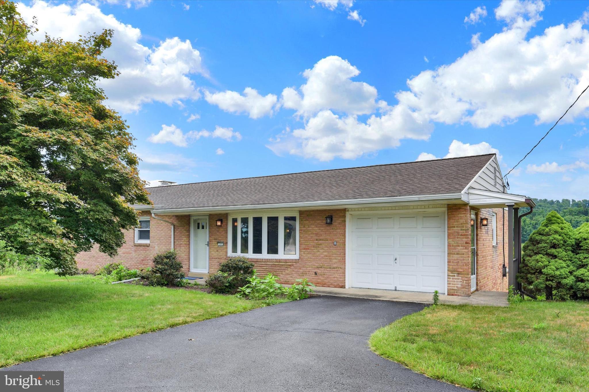 Welcome home to this beautifully maintained rancher located in the highly desirable West Shore School District!  Offering 3 bedrooms and 2.5 baths, this home features hardwood flooring throughout the entire first floor, creating a warm and inviting atmosphere. The finished walkout lower level provides additional living and entertaining space, complete with a cozy fireplace. Enjoy year-round comfort with central air conditioning. The primary suite includes a private bath featuring Corian countertops and a tasteful tile backsplash. Additional storage can be found behind the garage, providing plenty of room for seasonal items and tools. Conveniently located and move-in ready, this home combines comfort, functionality, and charm in one outstanding package.