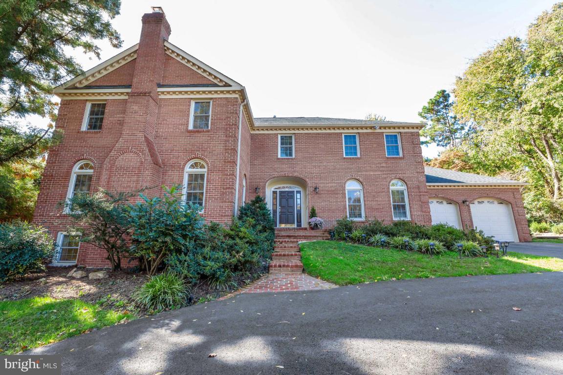 Stately All Brick Solid Colonial with Large Bedrooms. Gorgeous Hardwood throughout. 4 Fireplaces. Southern Exposure for Sunlight Galore. Master Suite with His/Her Separate Vanities. Expansive Brick Patio.  1/2 Acre lot. New Driveway, 2-Car Garage w/Storage. Finished walk-up Basement with Steam Shower and wet bar.. Spring Hill, Cooper, Langley HS. Come fall in love.