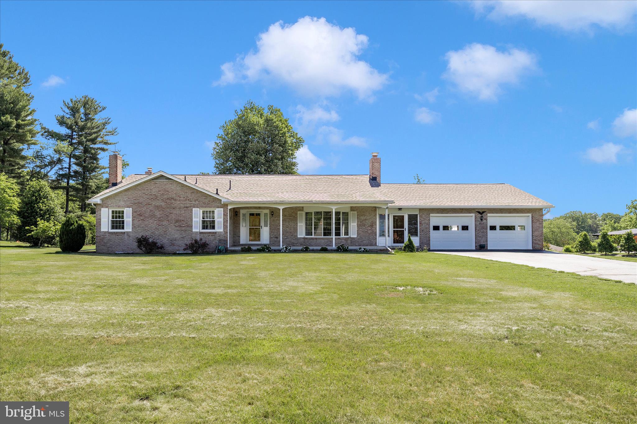 This lovely all brick rancher is situated on a .85 acre lot on the "Boulevard", Jefferson Boulevard in popular Braddock Heights. Truly one level living at its best! You will love the oversized front porch, what a great place to welcome family and friends. Step inside to the foyer and see the gorgeous hardwood floors that seem to only get better with age and that continue throughout the first floor. The large living room is highlighted with a bay window and the kitchen features granite counters, lots of wood cabinets, a built in desk, pantry and there is a separate laundry room with laundry tub nearby. The dining room includes a newer patio door with interior blinds that leads to a large concrete patio. The primary bedroom includes 3 closets, ceiling fan and a full bath with ceramic floor and shower. Two additional bedrooms each having spacious closets, ceiling fans and those lovely hardwood floors. The hallway includes a large linen closet and full bath with additional linen closet and ceramic floor and tub surround.  There is so much more! Downstairs the family room comes completely furnished and features a handsome brick fireplace with heatolator.  There is an additional finished room that could be used as an exercise/guest/rec room. This room has a lovely brick hearth with woodstove and has an adjoining half bath. The unfinished portion of the lower level has plenty of room for storage and outside entrance to the backyard and a brick hearth with second woodstove. The enclosed breezeway has had a ceramic floor recently installed and newer sliding glass doors on both ends that make this space sunny and bright.  The oversized two car garage has room for two vehicles and lots of remaining space for lawn equipment. There is a hatch with pull down steps to the attic space above.  This one owner home has been lovingly maintained and improved. Recent improvements include, roof in 2021, new tilt to clean replacement windows, water heater 2026, garage doors 2022.  Don't hesitate, come see this Braddock Heights beauty!  Did I mention Middletown School District!