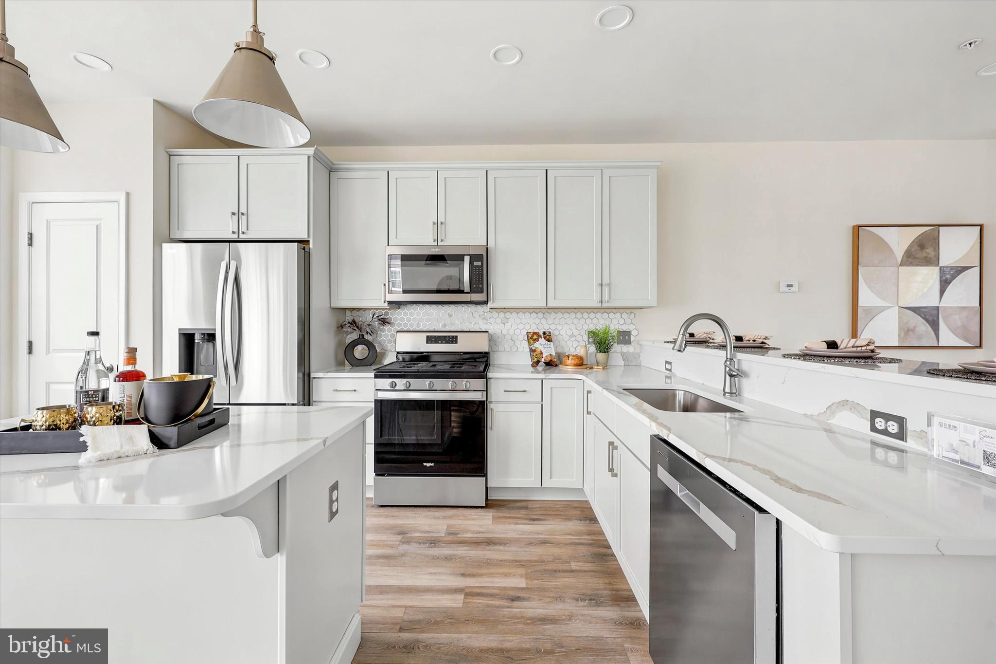 Stunning End-Unit Townhome | 4 Bedrooms | 2-Car Garage | Built Less Than 3 Years Ago

Move right into this beautifully upgraded end-unit townhome offering over 2,100 square feet of modern living space. Built less than three years ago, this 4-bedroom, 2 full and 2 half bathroom home combines the feel of new construction with today's most sought-after features.

The entry level offers a versatile home office, den, or flex space, a convenient half bath, and an oversized attached 2-car garage with plenty of storage.

The bright open-concept floor plan is perfect for entertaining and everyday living. The gourmet kitchen features quartz countertops, a large center island with seating, stainless steel smart appliances, abundant cabinetry, and a spacious dining area. Large windows provide exceptional natural light, and sliding doors lead to a private balcony—ideal for morning coffee or evening relaxation.

The spacious primary suite includes a large walk-in closet and a spa-inspired en-suite bathroom with a soaking tub, oversized walk-in shower, and double vanity. Two additional bedrooms, a full bathroom, and a second-floor laundry room complete the bedroom level.

The top floor features a spacious fourth bedroom or loft, perfect as a guest suite, bonus room, media room, playroom, or additional home office.

Enjoy low-maintenance living with HOA services that include lawn care, snow removal, trash service, and common area maintenance. Community amenities include a dog park, walking and jogging trails, and beautifully maintained green spaces.

Ideally located within walking distance to parks, cafés, coffee shops, restaurants, ice cream shops, boutiques, and everyday shopping, with easy access to major roads, commuting routes, and nearby conveniences.

This move-in ready, like-new townhome offers the rare combination of an end-unit location, 4 bedrooms, attached 2-car garage, home office, open floor plan, and modern finishes—all in one exceptional home.