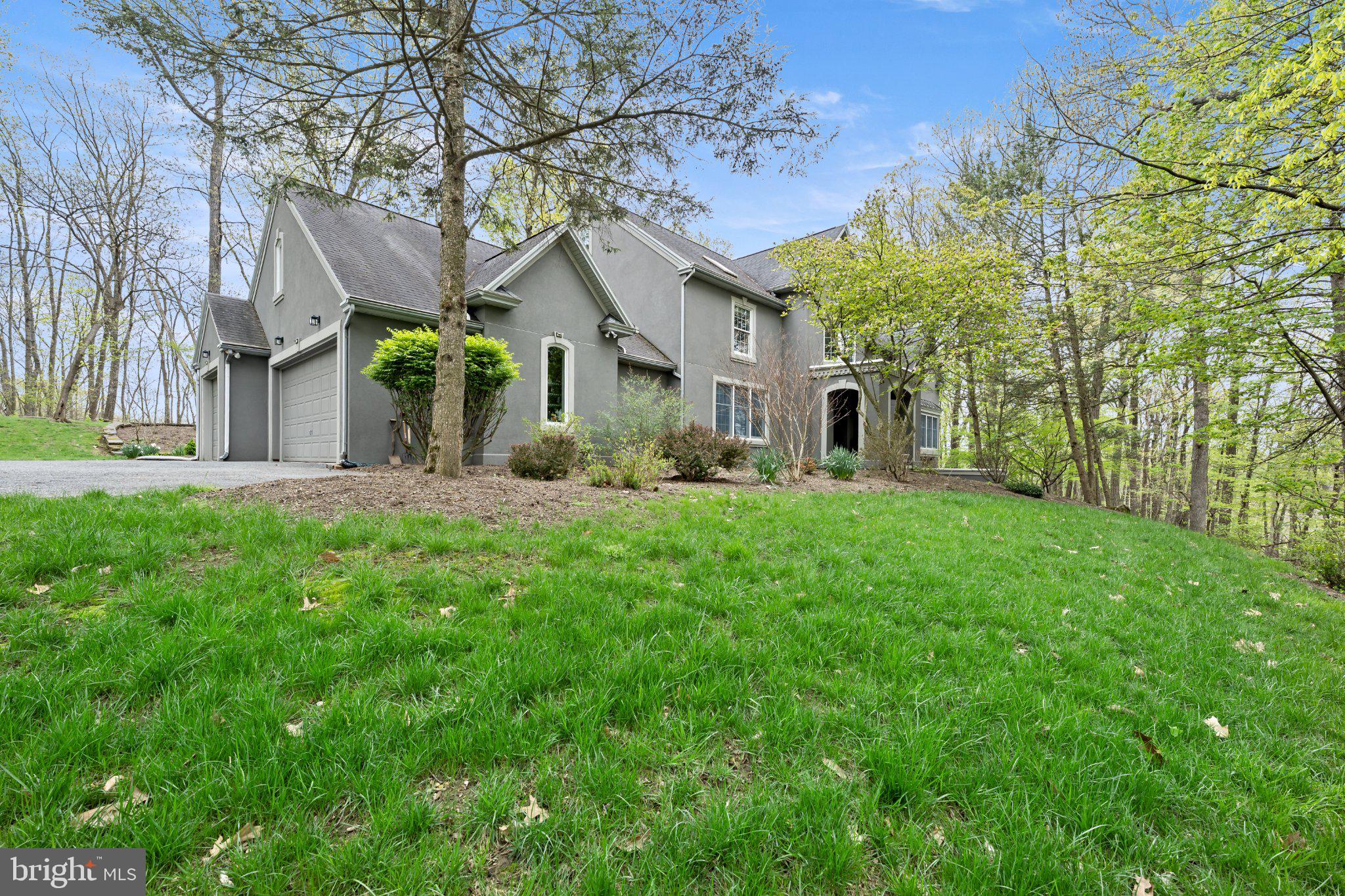 Welcome to 6688 Haasadahl - an extraordinary private estate where luxury, seclusion, and breathtaking Lehigh Valley views come together on more than 5.5 wooded acres. Tucked away in a serene natural setting within the highly sought-after Parkland School District, this exceptional residence offers the perfect balance of refined elegance and everyday comfort. Expansive windows showcase panoramic vistas and flood the home with natural light, while a dramatic double-sided fireplace creates a stunning focal point connecting the main living spaces. The luxurious primary suite is a true sanctuary, featuring a spa-inspired bath with a soaking tub positioned beneath a skylight and oversized window, creating a peaceful retreat surrounded by woodland views and natural light. Designed for creature comfort and flexibility, the finished walk-out lower level offers endless possibilities for a home theater, fitness studio, game room, guest quarters, or multi-generational living space, all with direct access to the tranquil outdoor setting. Every detail reflects thoughtful craftsmanship, custom finishes, and timeless design. Despite its secluded feel, the property is conveniently located near major commuter routes, leading employers, and premier healthcare systems including Lehigh Valley Health Network and St. Luke's University Health Network. Rarely does a property offer this combination of privacy, acreage, luxury, and convenience. 6688 Haasadahl is more than a home - it's a destination, a retreat, and a lifestyle.