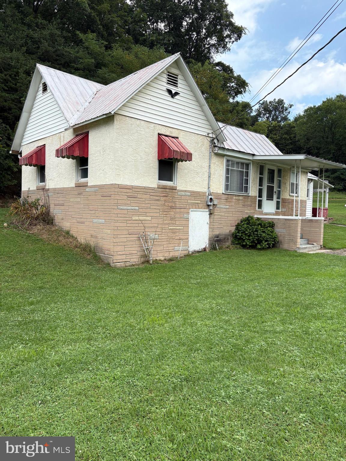 2 Bedroom 1 Bath bungalow located on a pristine 1 ac +/- unrestricted lot approximately 1 mile outside of Moorefield.  Conveniently located near to town for shopping, schools, and entertainment.  Make it your forever home or a weekend getaway.  24 x 12 detached garage and 10 x 14 storage building.  Public water and sewer. Nice area for garden.