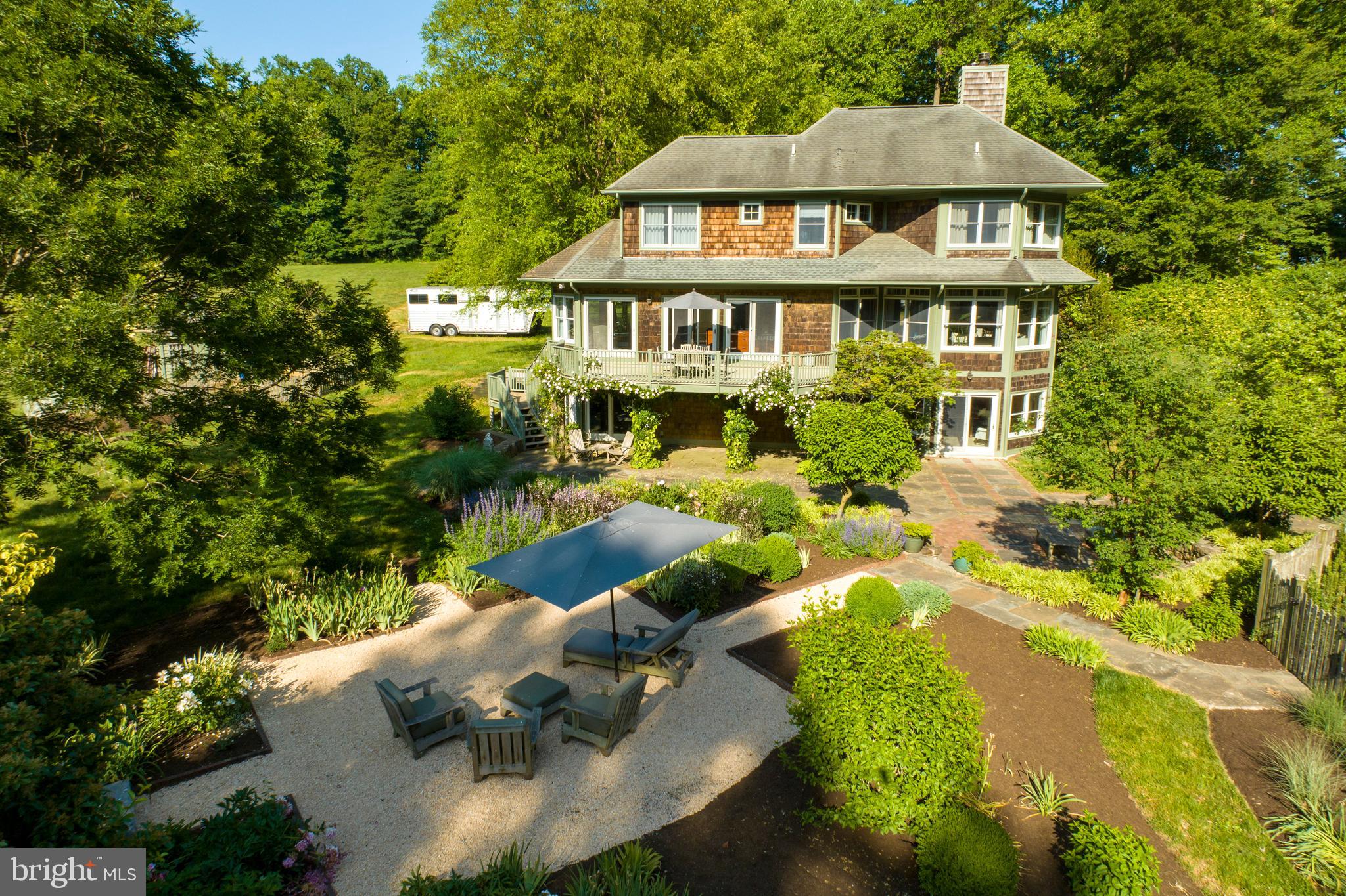 260 Hood Road is a beautifully designed 1999 custom colonial, with the
charm of a New England coastal home, nestled in the heart of Chester
County’s horse country. Neighboring top Olympic level equestrian training
facilities and near international competitions of all disciplines, this property
is a horse enthusiast’s dream. With views of rolling hills, proximity to miles
of preserved land trust and more than 10 acres for your animals, this
property offers the perfect opportunity to build your dream country retreat.
The external features of this property emit charm, with a circular pebble
driveway, stone walls surrounding the flagstone patio, gorgeous vegetable
& flower gardens, and an orchard. The heated pool is surrounded by a
picket fence, with an adjacent fire pit area for evenings relaxing with family
and friends. On the southeast side of the property is a large cleared area,
just perfect for grazing animals and your vision for a barn or detached
garage.
The inside of this home is also built for entertaining, with bright, cheery
rooms, hardwood floors, 9 ft ceilings and windows that wrap around the
entire house. The gourmet eat-in kitchen is large and open, with a central
black granite island counter space, designed for the resident foodie or as a
place to gather with friends. The eat-in kitchen features custom cabinets,
updated appliances, a large pantry and adjacent large mud room with great
storage and closet space. From the kitchen area, there are sliding doors
that lead out to a large upper deck overlooking the pool and backyard. The
entry-level floor includes the open-format kitchen, family room, living and
dining rooms which boast 2 working fireplaces.
Upstairs there are 3 bedrooms and 2 full baths. The primary bedroom
features spacious walk-in closets and a large bathroom with a soaking tub
and large tile shower.
Downstairs there is a tastefully designed walk-out basement with custom-
built wood cabinetry, an office, a yoga/exercise room, and a TV/movie room
with a full-service bar (sink, wine refrigerator and cupboard). This lower
level area, which exits to the flagstone patio and pool, thoughtfully includes
a full bath and changing room.

The house is 3,700 square feet, including the fully finished basement. 2
Zone Central air; electric service is 200 amps, forced air heat with heat
pump and electric back up; electric hot water; on site well and septic.
The property abuts thousands of acres of open space and is surrounded by
large equestrian properties in the famed Cheshire fox-hunting country. In
addition, it is located within the award-winning Unionville-Chadds Ford
School District, in West Marlborough Township, Chester County.