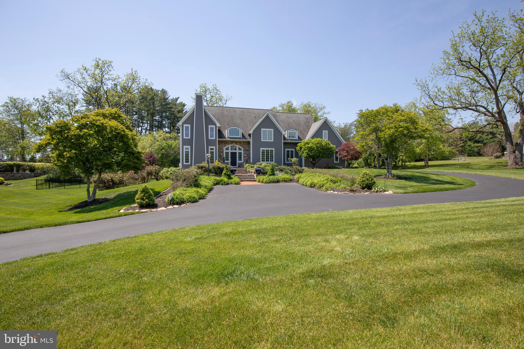 As you walk the welcoming brick and stone approach through manicured gardens, you instantly
recognize that 2840 Ashton Court is something really exceptional. That image is reinforced as
you enter the gracious foyer with gleaming wood floors, fine mill work details and soaring
ceiling, with sunlight pouring in through windows surrounding the front door. Off the foyer are an
elegant sitting room and stunning formal dining room. Straight ahead is the spacious family
room anchored by the stacked stone raised hearth fireplace with four-over-fifteen windows on
either side. More soaring ceilings, well-proportioned built-ins and wood floors make this room
one you want to relax and entertain in. The space flows comfortably into the
beautifully-designed kitchen with an abundance of custom cabinetry, new granite counters,
peninsula with seating, a wine fridge, a coffee bar, a 6-burner plus griddle Wolfe range with a
pot-filler, SubZero refrigerator, stunning tile backsplash, and an appealing breakfast area with
views out to the gardens. The main level also has a generously-sized office, a powder room,
laundry room and mud room. Upstairs the large primary bedroom boasts a lovely tile bath with radiant floor heat, jetted tub, separate shower and double vanities. The custom-designed closet is a show-stopper! Three additional bedrooms and two bathrooms complete the upper level.
The finished walk-out lower level provides additional living and entertainment spaces including a
full bath, large sitting room, work-out space, lots of room for projects and hobbies,a wine
cellar/tasting room. Outside, and off the family room and kitchen, are gorgeous gardens, a brick patio and paths,sweeping lawns and mature plantings, with extensive landscape lighting and a forest of newly planted fir trees. Among this home’s many amenities are a Generac Whole House Generator, reverse osmosis water system in the kitchen and water purification and water softener systems for the whole house, and many other upgrades and updates. The oversized (3-car) garage features an epoxy floor and Level Two Charger for electric vehicles. Proximity to the vibrant communities of Doylestown and New Hope, easy access to commuter routes and the award-winning Central Bucks School District, all add to the exceptional quality of this home.