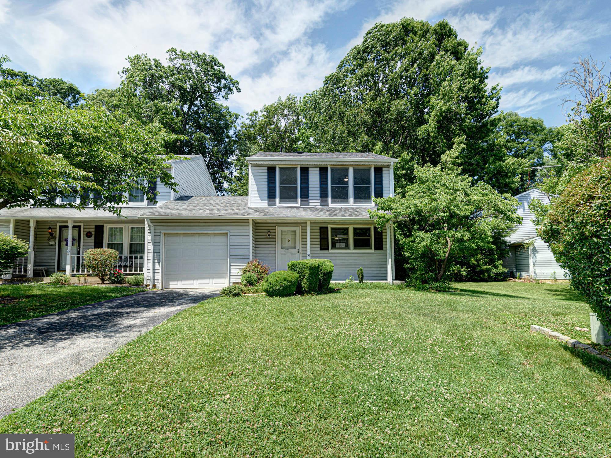 Welcome to 32 Lanford Road, where low-maintenance living meets comfort, convenience, and exceptional value! This charming carriage home offers the privacy, connected to its neighboring home only by the garage. Set on a beautiful lot backing to mature trees, you'll love the peaceful rear setting complete with a large deck perfect for morning coffee, summer barbecues, or simply unwinding after a long day. Its prime location within the community provides both privacy and convenience, with easy access to nearby shopping, dining, parks, and major commuting routes. Inside, this home has been thoughtfully refreshed with numerous recent updates, including luxury vinyl plank flooring throughout the main level, fresh paint throughout the home and on the deck, brand-new carpeting upstairs, updated fixtures, and more, creating a move-in ready space you'll immediately appreciate. The functional floor plan makes the most of every square foot. Just off the entry, the spacious kitchen offers plenty of cabinetry and workspace, while the open-concept living and dining area provides an inviting space for both everyday living and entertaining. A cozy fireplace serves as the focal point of the family room, and sliding doors lead directly to the rear deck and private backyard. A convenient powder room, laundry space, and generous storage spaces complete the main level. Upstairs, both spacious bedrooms are designed with comfort and privacy in mind, each featuring its own walk-in closet and private full bathroom, an ideal layout for guests, roommates, or anyone seeking separate personal spaces. Offering low-maintenance living, an efficient and highly functional floor plan, recent updates throughout, and a private tree-lined setting, 32 Lanford Road is proof that great things come in perfectly sized packages. Whether you're purchasing your first home, downsizing, or simply looking for incredible value in a sought-after location, this home is one you won't want to miss.