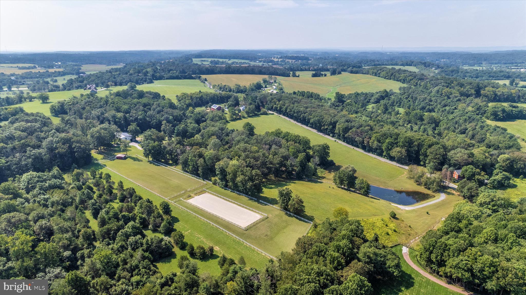 Welcome to this rare and spectacular Montgomery County estate that features premier equestrian facilities and a certified air strip. Set on 23 acres, just two miles from I-270, with breathtaking views of Sugarloaf Mountain this stunning 6,000 square foot contemporary residence nestles right into the landscape. Immediately upon entrance, you are presented with the heart of the home, a sunken living room with show stopping floor-to-ceiling windows, a large wood burning fireplace, and gorgeous hardwood floors that continue throughout the main levels of the home. The open floor plan flows into the spacious, gourmet kitchen where a bright and airy formal dining room adjoins. Just outside, youâll find a secluded swimming pool and expansive, private views of the entire property. This home features 5 bedrooms, each with en-suite bathroom, two additional sitting rooms and a large recreational area on the lower level. This is an equestrianâs dream property. The meticulously crafted 6-stall barn features amenities in each stall that include: heated automatic waterers, a fly spray system, blanket racks and turnout directly connected to the stalls. The center aisle flooring is optimally designed to ensure equine and pedestrian safety with non-slip pavers. There is also a heated wash stall with hot and cold water. An auxiliary laundry and restroom as well as a heated tack room enhance the luxury amenities of this stable. Additionally, there is a small indoor area that is ideal for light hacking or the perfect place for safe turnout during less than ideal weather. Two additional full size stalls are located in a nearby pasture, bringing the total to 8 beautiful, working stalls. Near the barn and set amid lush pastures with individual water spigots and run-in facilities, is a regulation sized dressage arena (20x60) with sand and bluestone footing and an incredible drainage system. Finally, the capstone to this exceptional property is a separately deeded 5-acre parcel that would be the perfect setting for an additional home. This parcel is also certified as an air strip. Engaged for equestrian purposes today, the area can revert to use a runway and/or as a helipad. Rarely does a property with the breadth and quality of amenities that this estate offers become available. The perfect venue for large or small gatherings both indoors and outside, and whether formal or casual this is a home for all seasons. Please note that there is an Agricultural Reserve in place as a portion of the acreage is used for growing hay.