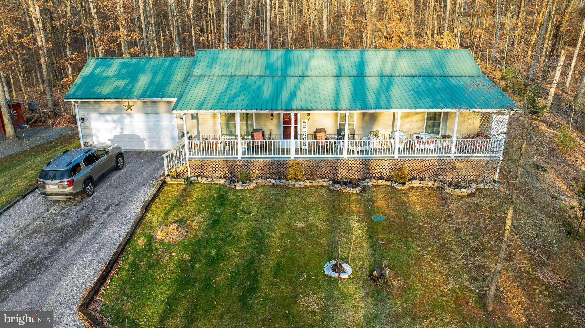 Bring the chickens, turkeys and goats to this 2.7 acre UNRESTRICTED property! It is a wonderful opportunity for anyone looking for a rural lifestyle with plenty of space for animals and outdoor enjoyment. Situated on 2.7 wooded acres with mountain views this 3 bedroom, 2 bathroom home features a large living room w/ fireplace, country kitchen and updated appliances, and master bedroom which has en-suite bath. The unfinished basement provides opportunity for customization and expansion of living space. There is $2k-3k worth of materials already in basement included in sale for future finishing. My favorite part is the large front porch and the backyard is ideal for outdoor gatherings with the pool, gazebo, and fireplace. Along the side of the property there is a chicken coop, shed for the turkeys/animals, fenced in area previously set up for goats and another shed included for storage. This property offers a blend of comfortable living, outdoor enjoyment, and potential for lots of animals if that's your thing!
