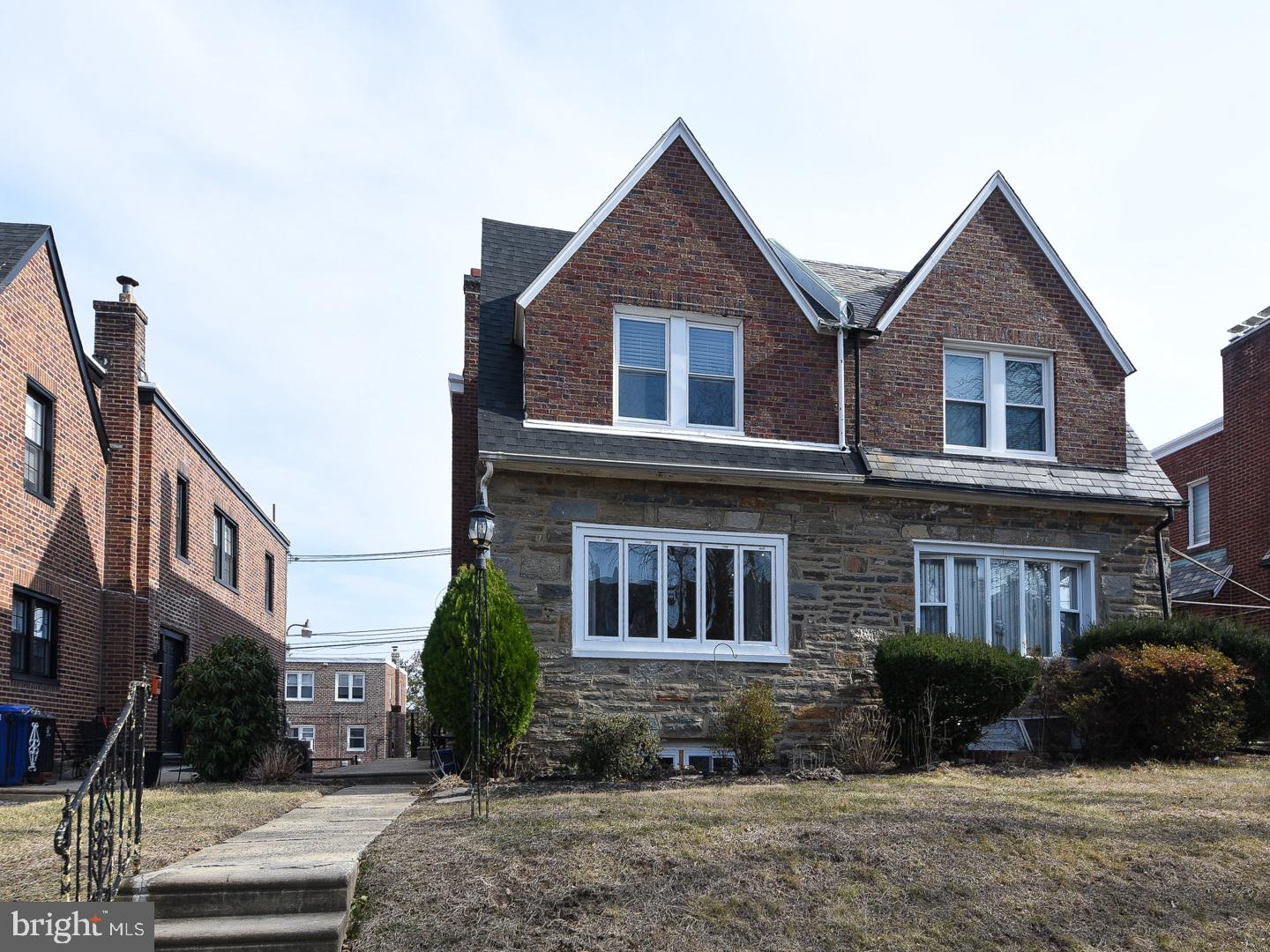 Welcome Home! This well maintained 3-bedroom, 2.5 bath stone and brick twin home in the desirable East Mt. Airy neighborhood of Philadelphia is ready for a new owner! From its timeless charm to its thoughtful updates, this property offers everything you need and more. Warm parquet flooring carries through the living and dining areas seamlessly. A spacious living room is a perfect haven for cozy evenings, and features recessed lighting, a ceiling fan, and a large bay window that floods the space with natural sunlight. The elegant dining room, also with recessed lighting, provides an ideal setting for formal gatherings. The updated gourmet kitchen is a chef’s dream, featuring tile flooring, 42” cherry cabinetry with soft-close doors and drawers, a stylish tile backsplash, gas cooking, stainless steel appliances, and recessed lighting. A door leads to the rear yard, adding convenience and functionality. The first-floor bonus room offers versatility as an office, playroom, or creative space. A beautiful wood staircase leads to the second floor, which boasts vinyl flooring and conveniently placed laundry with additional storage cabinets which makes doing chores a breeze. The primary bedroom suite is a tranquil retreat, featuring the parquet hardwood floors, recessed lighting, and a ceiling fan. The en-suite bathroom is updated with tile flooring and walls, a pedestal sink, and jetted tub. The second and third bedrooms are equally inviting, with the same flooring, recessed lighting, and generous closet space. The updated hall bathroom completes this level with a tiled stall shower, pedestal sink, skylight, and tasteful tile finishes. The finished basement offers an additional 350 square feet living space with vinyl flooring, recessed lighting, and a convenient powder room. Perfect for movie nights or family game time, this space also provides direct access to the garage, including a garage door opener for added ease. Situated just minutes from shopping, dining, and entertainment, this home offers unmatched convenience. Local favorites like Cedarbrook Plaza, Greenleaf at Cheltenham, and Lovett Library are all nearby. Commuting and city adventures are a Breeze with easy access to major highways, public transportation, and the SEPTA train line! This property is more than a house—it’s your “Home Sweet Home”! Don’t miss the opportunity to make it yours!