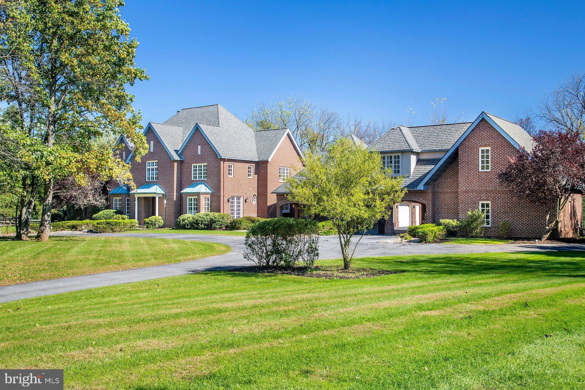 It is a rare pleasure to encounter such a Saucon Valley property, set amidst rich landscaping & glorious gardens, on a park-like 2.4 acres. Wildberry is designed to take full advantage of an ideal location at the end of a Saucon Valley cul-de-sac. Nearby, the residences are unique, both for their timelessness & for their ability to reflect the natural surroundings in their design, with an orientation towards spectacular landscapes, Wildberry is an example of this marriage of land & home. Truly beyond the imagination and enticing one to stay forever, Wildberry is a premiere estate property.  The timeless design offers a floor plan featuring spacious rooms in more than 9,686 sqft on 3 levels.  A wealth of custom details & a sophisticated, yet functional, floor plan attest to a thoughtful design. Romantic details combine with ceramic, marble, wood & granite accents to create a rich & warm atmosphere in spaces of grand proportions that invite one to entertain.  The living room is highlighted by a southwest style fireplace, creating an inviting ambiance & serving as a dramatic introduction to the rooms to come. The gourmet kitchen was designed as the heart of the home and plays its part with ease. The appliances are top-of-the-line, with both Dacor gas & Jenn Aire cooktops, 2 Asko dishwashers, Sub-Zero refrigerator, freezer, freezer drawers & refrigerator drawers, & Dacor double ovens.  2 center islands with granite counters make cooking & entertaining a breeze. Custom cabinets, wet bar, home office & pantry provide the perfect complement for entertaining as well. Steps away, the great room boasts a beamed cathedral ceiling, walls of glass, & a floor-to-ceiling stone fireplace.  Also on the 1st floor is a formal dining room with walls of glass to the front courtyard, an office & an exercise room. Completing the 1st floor, a master bedroom features a wood-burning fireplace, cathedral ceilings, floor to ceiling windows, & doors to a private, walled, back patio. The master bath & walk-in closets will provide fabulous additional spaces to pamper and soothe. On the 2nd floor there are 4 additional bedrooms, while a 3rd floor retreat with full bath offers a variety of uses for extended living space.  Finally, the lower level has abundant room waiting to be finished with amenities such as a home theatre & any additional family needs one might envision. Outside, the home is serenely set & prominently positioned, enveloped by mature trees, manicured lawns, & perennial gardens.  There are lovely outdoor living spaces with patios & private vistas, all overlooking a Koi pond, pool & spa … in a bucolic setting of natural beauty. A 2-car garage is attached, & a porte-cochere adds 2 additional garages with a fully finished guest suite above.  It is a privilege to experience such a home & a special joy to offer this property for sale.