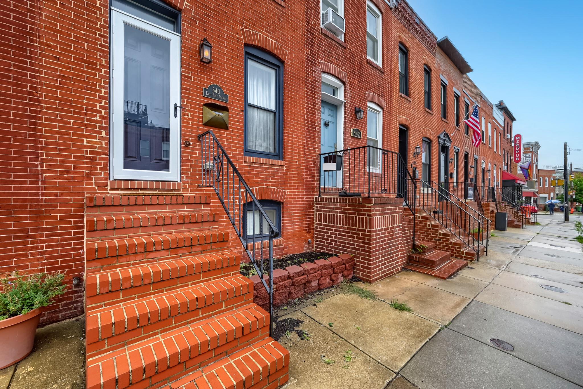 Experience the perfect blend of historic Baltimore charm and sophisticated modern living in this beautifully renovated Riverside townhome, ideally located just one block from the iconic Riverside Park.

Thoughtfully renovated in 2018, this exceptional residence showcases timeless character enhanced by high-end finishes and contemporary design. The inviting main level features an elegant living room with a fireplace insert, exposed brick accents, custom shiplap details, designer lighting, and a spacious dining area ideal for entertaining.

The chef-inspired kitchen is truly the heart of the home, designed with both style and functionality in mind. Featuring a large center island with seating, luxurious marble countertops, 42-inch white shaker cabinetry, brushed champagne hardware, stainless steel appliances, abundant storage, and abundant natural and recessed lighting, this space is perfect for everyday living and hosting guests.

Retreat to the serene primary suite, complete with custom his-and-her closet systems and a spa-like en-suite bath featuring a double vanity, marble tile finishes, elegant brass accents, and generous storage. A spacious second bedroom comfortably accommodates a queen-sized bed and is conveniently served by a beautifully appointed full hall bath.

Adding versatility to the home is a sun-filled bonus room, ideal for a home office, reading nook, fitness space, or creative studio. Just beyond, enjoy a private rear porch perfect for grilling, al fresco dining, or unwinding with your favorite beverage after a long day.

The fully finished lower level expands your living and entertaining options with a recreation room featuring a custom bar, mounted television, and sound system. A dedicated laundry area and additional storage complete this level.

Parking is effortless with a rare two-car parking pad accessible from a wide alley—an invaluable city convenience. Create a charming front garden that will provide a warm welcome for guests and enhance the home's curb appeal.

Additional updates completed during the renovation include new plumbing, electrical systems, water heater, central HVAC, exposed brick detailing, hardwood flooring throughout (including some original hardwoods), and soaring 9-foot ceilings that maximize the home's spacious 12-foot-wide footprint.

Located in one of Baltimore's most sought-after neighborhoods, you'll enjoy easy access to Riverside Park, the Inner Harbor, the Promenade, Federal Hill, Historic Fort McHenry, M&T Bank Stadium, Camden Yards, popular restaurants, neighborhood cafés, shopping, and major commuter routes including I-95.

This is urban living at its finest—where historic character, modern luxury, and an unbeatable location come together to create an extraordinary place to call home.

Select furnishings may be available for purchase outside of settlement.