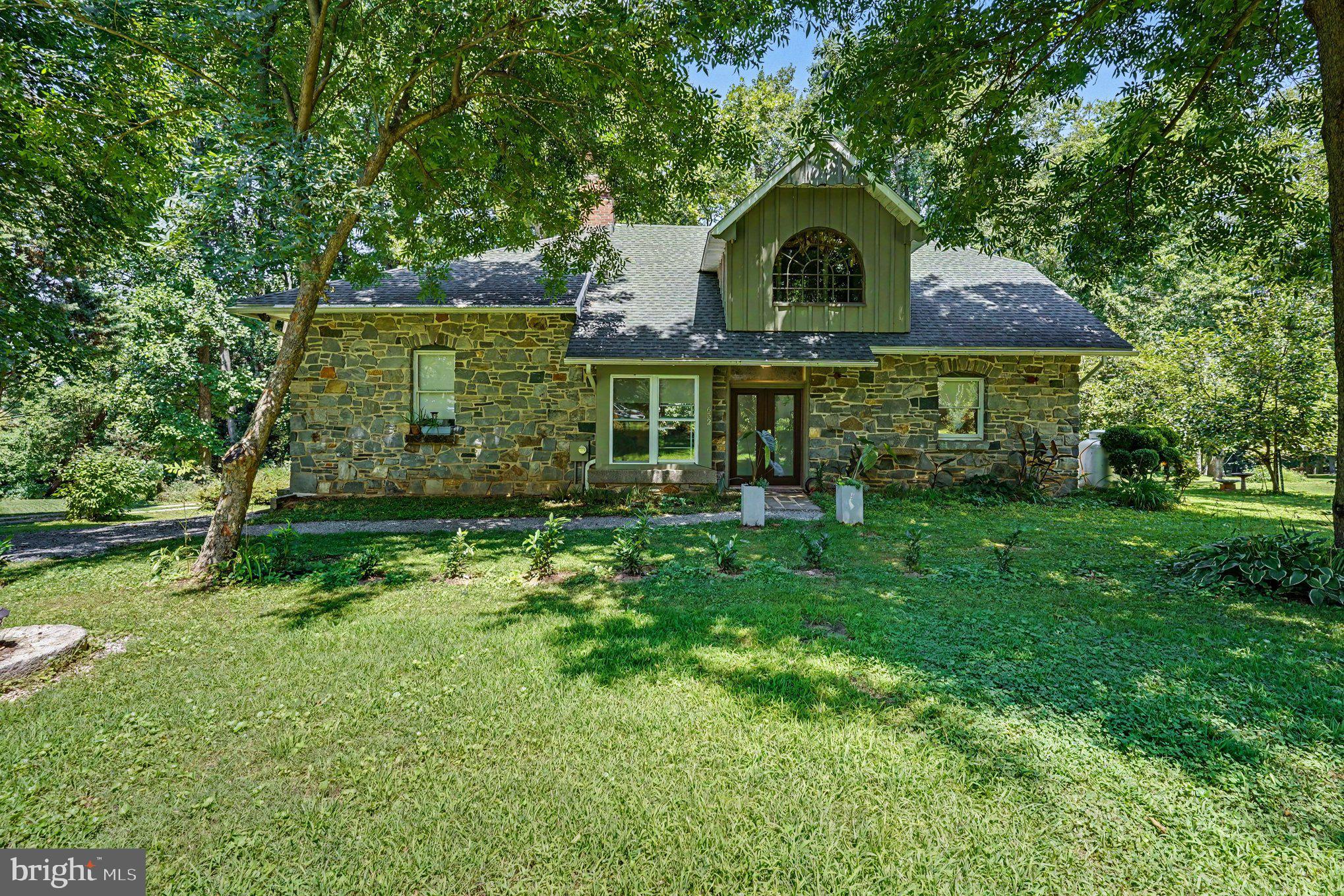Welcome to 652 Liberty Grove Road.  Amazing and truly unique custom built home in a quiet natural setting surrounded by trees. At every turn you will find interesting artistic touches that make this home fascinating. Built with extra strength from the foundation up. Notice the double arch support structures and  massive granite ledges. 2x6 framing walls and 12" center strong Douglas Fir joist support.
Rear exterior wall is porcelain. Side walls are stucco and front wall is granite. Architectural shingle roof.
Lovely landscaped grounds and a detached barn style garage. Inside you will find a huge family room with stone mantle fireplace and 12 ft ceiling. Formal dining area, large kitchen with granite counters and custom cabinets. Main level full bath and primary bedroom with private half bath. Upstairs a landing with a beautiful large arch window overlooking the front grounds. 2 bedrooms and 2nd full bath. Lower level has 2 additional large bedrooms, exercise room, combo kitchen and recreation room and 3rd full bath with private commode. Utility room and potential wine cellar.  It also has a level walk out to rear driveway.
Large rear 24x12  composite deck with automatic awning overlooking a wooded landscape.
Propane heating system recently installed. Brand new Central AC with full price offer.
This is a one of a kind home. Make it yours...