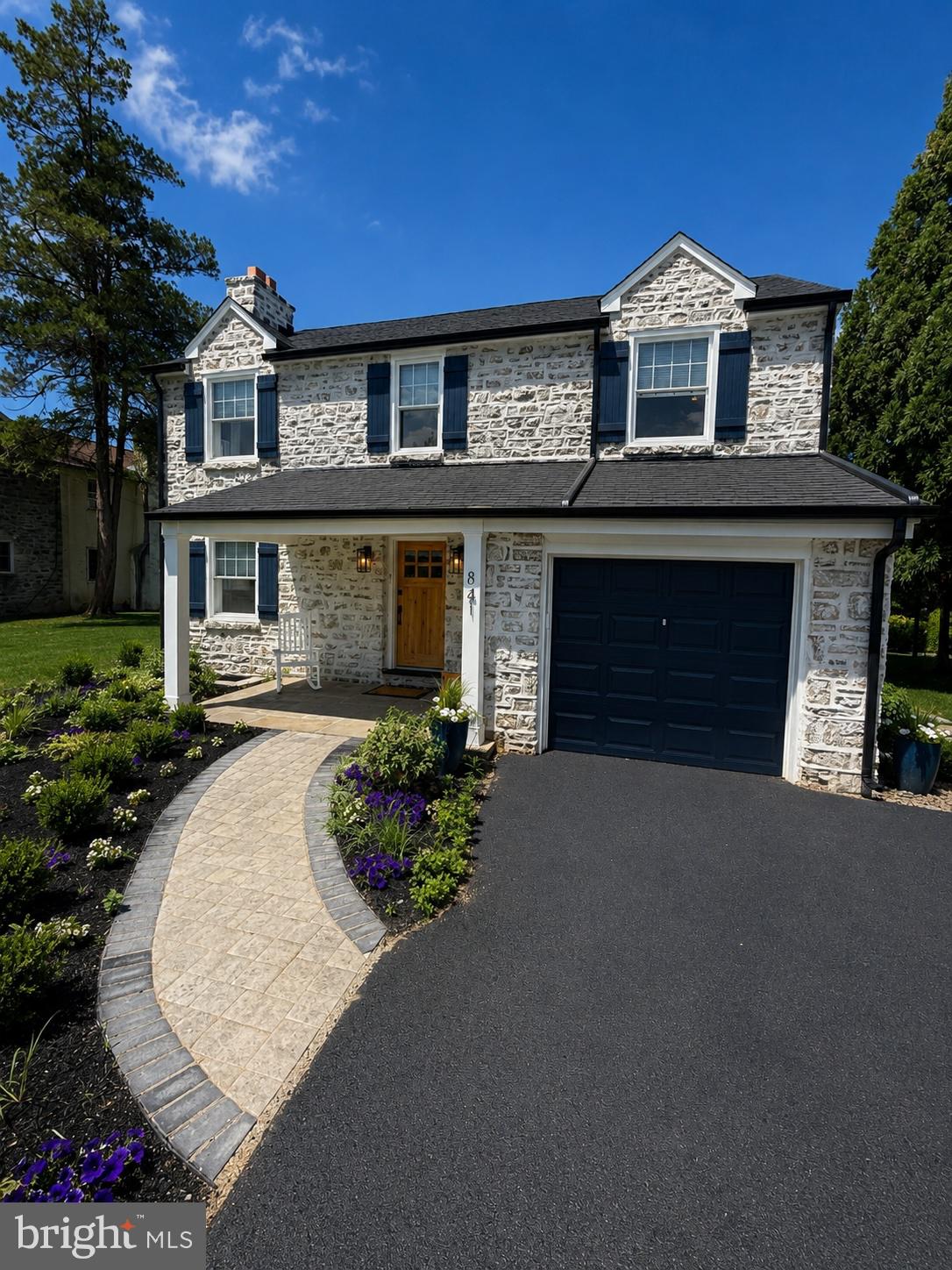 Nestled in the highly sought-after Broad Axe Village neighborhood of Ambler, this beautifully renovated 4-bedroom, 1.5-bath stone Colonial seamlessly blends historic charm with modern luxury. Thoughtfully updated, this exceptional home showcases timeless finishes, and attention to detail at every turn.
The striking stone exterior, accented by a German schmear finish, classic shutters and tastefully designed landscaping, creates unforgettable curb appeal. Inside, you'll find all-new flooring throughout, a stunning kitchen, completely renovated bathrooms, updated lighting, and carefully curated finishes that complement the home's original character.
The bright, open kitchen features custom cabinetry, quartz countertops, stainless steel appliances, and elegant fixtures, flowing effortlessly into the dining are, perfect for everyday living and entertaining. The spacious living room highlights the home's stone fireplace while offering a fresh, sophisticated aesthetic.
Upstairs, four bedrooms provide comfortable accommodations, while the beautifully remodeled bath features luxury tile work, modern fixtures, and meticulous attention to detail.
Step outside to your own private backyard retreat. The refurbished in-ground pool serves as the centerpiece of the outdoor living space, surrounded by an expansive patio ideal for entertaining, outdoor dining, or simply relaxing in the sun. This property is an inviting setting for family and guests alike.
Just minutes from Ambler's vibrant downtown, restaurants, shopping, parks, and major commuter routes, this turnkey property is truly move-in ready.