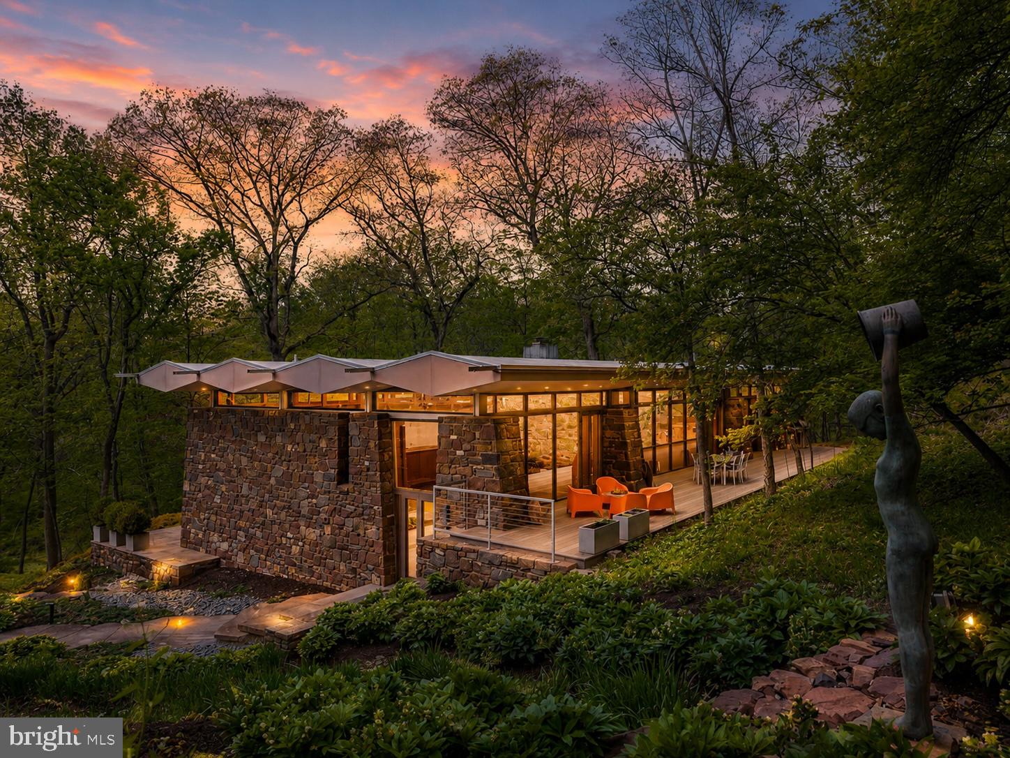 Originally constructed in 1959 and masterfully completed in 2014 following Paul Rudolph’s original architectural vision, The Fullam House stands today as a fully realized and enduring work of design, where historic integrity and modern refinement exist in perfect balance. The completion earned the prestigious AIA Bucks County Design Award for Excellence, recognizing the seamless integration of original architecture with thoughtful modern enhancements.
Conceived by Paul Rudolph, one of the most celebrated architects of the 20th century and former Chair of Architecture at Yale University, this extraordinary residence represents a rare and deeply personal work created during a pivotal moment in his ascent to international prominence. Known for his bold experimentation, sculptural forms, and leadership in the modernist movement, Rudolph’s work helped redefine American architecture in the postwar era.
Created for Judge John Fullam and his wife Alice, the home was born from a lifelong friendship that began during their years at Harvard. This was not a speculative project, but a deeply personal collaboration, where Rudolph was given creative freedom to explore new architectural ideas beyond his well-known Florida works.
At the request of the Fullam family, the home was intentionally never published during Rudolph’s lifetime, remaining an unpublished architectural work thoughtfully situated within the Bucks County landscape for decades. This allowed Rudolph to experiment with evolving concepts, including the interplay of mass and void, sculptural geometry, and environmental responsiveness, resulting in a design both ahead of its time and deeply connected to its surroundings.
Set on over 26 private acres, the property is seamlessly integrated into its natural environment, nestled into the hillside and overlooking a dramatic ravine. Constructed with Pennsylvania fieldstone, the residence reflects both Rudolph’s modernist philosophy and a nod to the local Bucks County vernacular. Beyond the home itself, the estate offers an exceptional lifestyle with a private full-size tennis court, beautifully positioned within the wooded landscape, creating a secluded setting for recreation, entertaining, or peaceful enjoyment of the surrounding natural beauty.
Architecturally, the home is a study in light, structure, and spatial experience. A central open living pavilion forms the heart of the residence, flanked by private wings, creating a deliberate separation between public and private spaces. Floor-to-ceiling window walls, clerestory glass, and a distinctive floating roofline allow natural light to move dynamically throughout the home while framing uninterrupted views of the surrounding landscape.
Rudolph’s forward-thinking approach to environmental design is evident throughout. The sculptural roofline is both visually striking and functional, designed to block high summer sun while allowing winter light to penetrate deeply into the home, naturally warming the thick stone walls which then radiate heat into the space.
Inside, the residence offers approximately 3,500+ square feet, including 4 bedrooms and 3.5 baths, with living spaces that feel both expansive and intimate. The interplay of stone, glass, and wood creates a tactile richness, while the home’s multi-level design provides a unique spatial experience.
The 2014 completion faithfully realized Rudolph’s original intent while integrating modern systems and efficiencies. Surrounded by complete privacy, yet within close proximity to New Hope, Princeton, and major metropolitan areas, The Fullam House offers a rare convergence of architectural pedigree, historical significance, and modern livability.