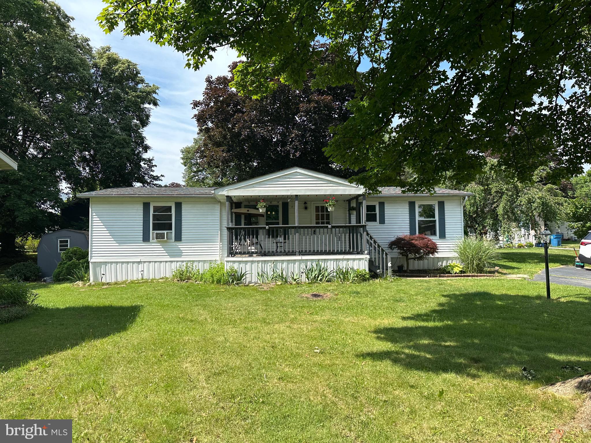 If you are looking for a move in ready home with  3 bedroom,  2 bath and lots of charm , you’ve found it.A large front porch invites you into an open concept mixed with some old world design to please everyone. The kitchen has all stainless appliances and an island for convenience. There are two tub showers in the bathrooms. There is also a rear deck that opens to a sizable yard. The $ 941 monthly lease fee includes 1500 gallons of water/sewer use, mini golf ,chip and putt, fishing ponds pool,and use of the community hall for private functions. Park approval required