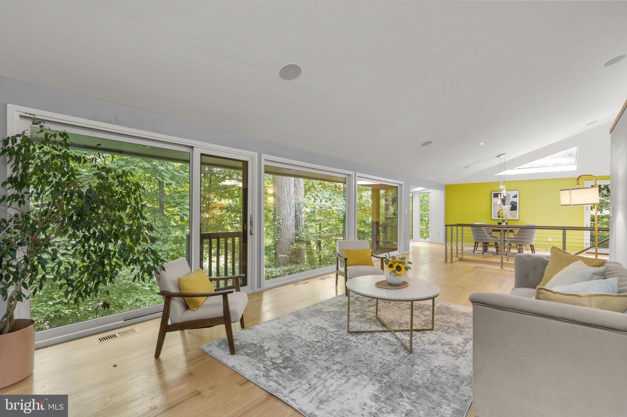 Proudly presenting this one of a kind, rare experience for the area completely rebuilt and beautifully Renovated Mid-Century Modern Home in Glen Echo Heights.  Agents and Prospective Buyers, please do not be misled by the home's taxable square footage, as home is built into hill and most living square footage is above ground (2,879 sq. ft. finished total living area).  
<p>
Upon entering home, you are met by reconfigured open floor plan with wide plank hardwood flooring throughout the main level, kitchen with Christina Soft Close Cabinets, Wolf Double Ovens, Jenn-Air Downdraft Stove located on Stainless Steel Island with Caesar Stone Quartz, SubZero Stainless Steel Refrigerator, Farmhouse Sink and Custom Multi-Color Honeycomb Tile that flows into Dining Area, modern Bathroom and Living Area with Gas Log Fireplace and Stone Accent Wall.  Expansive Floor to Ceiling Windows provide completely uninterrupted views of tree-lined back yard and complete privacy, overlooking nature from the top of a hill. Primary en-suite located on main level with walk-in closet or office space and primary bathroom with Boffi sink, modern soaking tub, step-in tile shower with waterfall faucet and marble accent wall throughout. 
<p>
Open modern staircase leads to downstairs living area or office with tile that also overlooks nature and privacy.  Three bedrooms downstairs provide private space for family, friends and guests and are adjoined by second renovated full bathroom with soaking tub, step-in shower and Porcelanosa dual vanity sinks.  
<p>
The home is equipped with Dual Zone Heating and Tankless Water Heater.  Exterior boasts large patio area for entertaining and two car carport that is equipped with EV Charger and extra parking in a quiet pipe-stem with only four total homes. 
<p>
The neighborhood is located with the Walt Whitman HS district and includes parks and playgrounds nearby.  It also located around the corner from I495, Clara Barton Parkway and Metro for commuting purposes, Glen Echo Park for retail, restaurants and additional park space, the C & O Canal, Potomac River and is minutes from the DC Line and Embassy Row.  This is an incredible opportunity to live in an environment that escapes the busy day to day of Washington DC, do not miss it!