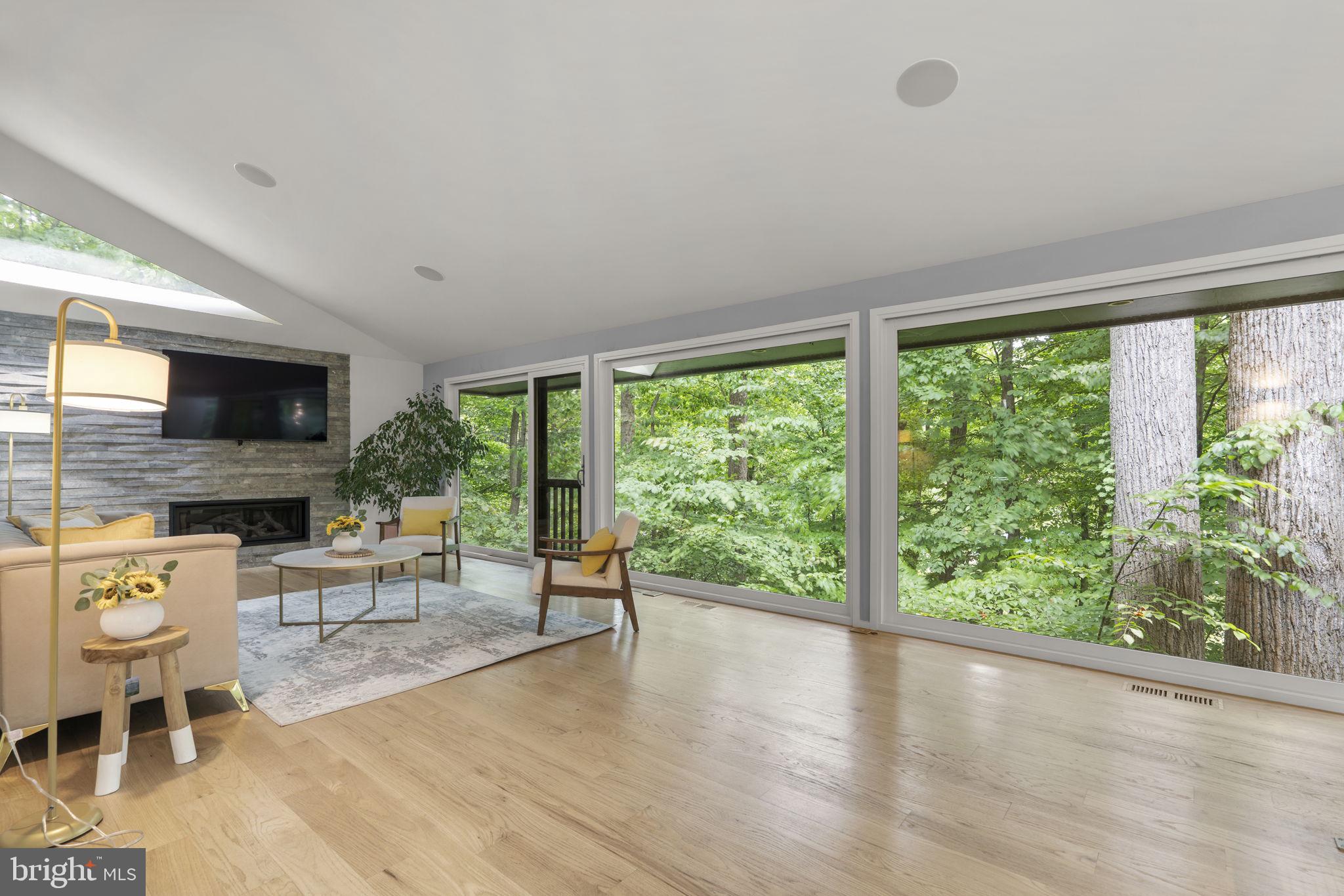 Proudly presenting this one of a kind, rare experience for the area completely rebuilt and beautifully Renovated Mid-Century Modern Home in Glen Echo Heights.  Agents and Prospective Buyers, please do not be misled by the home's taxable square footage, as home is built into hill and most living square footage is above ground (2,879 sq. ft. finished total living area).  
<p>
Upon entering home, you are met by reconfigured open floor plan with wide plank hardwood flooring throughout the main level, kitchen with Christina Soft Close Cabinets, Wolf Double Ovens, Jenn-Air Downdraft Stove located on Stainless Steel Island with Caesar Stone Quartz, SubZero Stainless Steel Refrigerator, Farmhouse Sink and Custom Multi-Color Honeycomb Tile that flows into Dining Area, modern Bathroom and Living Area with Gas Log Fireplace and Stone Accent Wall.  Expansive Floor to Ceiling Windows provide completely uninterrupted views of tree-lined back yard and complete privacy, overlooking nature from the top of a hill. Primary en-suite located on main level with walk-in closet or office space and primary bathroom with Boffi sink, modern soaking tub, step-in tile shower with waterfall faucet and marble accent wall throughout. 
<p>
Open modern staircase leads to downstairs living area or office with tile that also overlooks nature and privacy.  Three bedrooms downstairs provide private space for family, friends and guests and are adjoined by second renovated full bathroom with soaking tub, step-in shower and Porcelanosa dual vanity sinks.  
<p>
The home is equipped with Dual Zone Heating and Tankless Water Heater.  Exterior boasts large patio area for entertaining and two car carport that is equipped with EV Charger and extra parking in a quiet pipe-stem with only four total homes. 
<p>
The neighborhood is located with the Walt Whitman HS district and includes parks and playgrounds nearby.  It also located around the corner from I495, Clara Barton Parkway and Metro for commuting purposes, Glen Echo Park for retail, restaurants and additional park space, the C & O Canal, Potomac River and is minutes from the DC Line and Embassy Row.  This is an incredible opportunity to live in an environment that escapes the busy day to day of Washington DC, do not miss it!