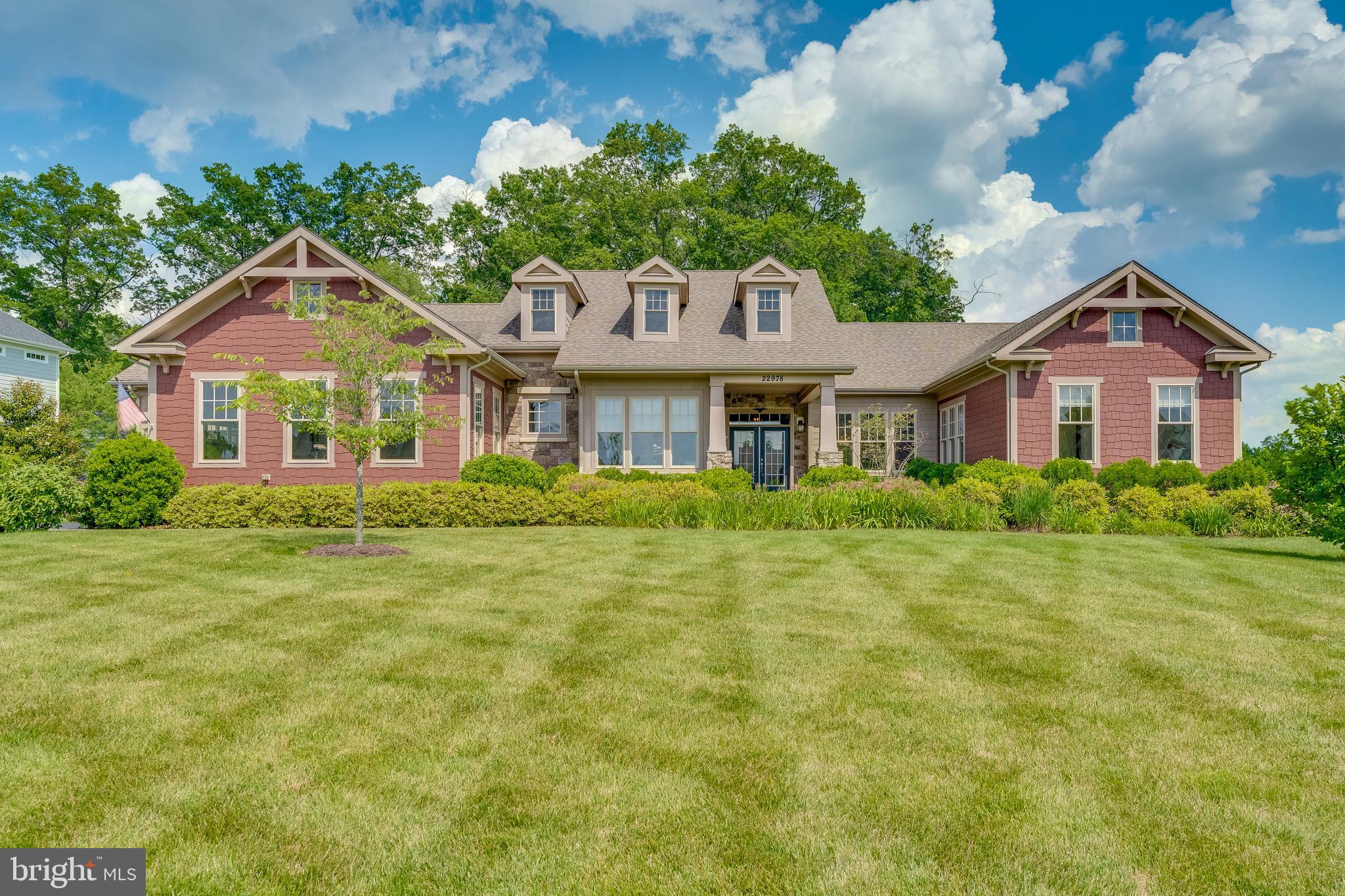 Welcome to your new luxury home nestled in the highly desired Grant at Willowsford neighborhood!  Located in the Independence HS cluster, this stunning Arcadia Home, Emerson Model, is built with superior craftmanship, high-end finishes, and an open floor plan to suit your family's needs. The entire main level living area has an abundance of windows to show off this .95 acre private lot and brings in tons of natural light and shows the beautiful aesthetic landscape that Willowsford has to offer.  Pristine hardwood floors flow throughout the entire main level including the luxury primary suite and gourmet kitchen.  Any chef would enjoy the amazing kitchen that includes a massive Sub-Zero refrigerator, Wolf appliances, granite countertops, a lifted island with tons of countertop space to prep and serve, a walk-in pantry, and a cozy breakfast nook to enjoy your morning coffee!  The sun-drenched primary bedroom features hardwood floors, private access to the outdoor space, a spa-like bathroom with expanded shower and large soaking tub, and a large walk-in closet to fit all of your clothes and accessories.  Enjoy quiet evenings in the open family room area that includes a stunning floor to ceiling stone veneer gas fireplace.  The study/office space is a quiet sanctuary to get away and work or read a book in front of the two-sided fireplace.  Entertain guests in the enormous fully finished basement with walk-up steps, wide plank hardwood floors, a guest bedroom with full bath, and spaces to build a theatre room, workout area, or golf-simulator.  The professionally installed landscaping around the entire home shows the attention to detail in the design of the stone walkway and porch in the front of the home along with the spacious trex wood deck and bluestone patio space.  Other features include: a 3 car garage, a long driveway, tons of basement storage space, a sprinkler irrigation system, security system, and privacy trees in the backyard.  Don't miss this incredible opportunity.