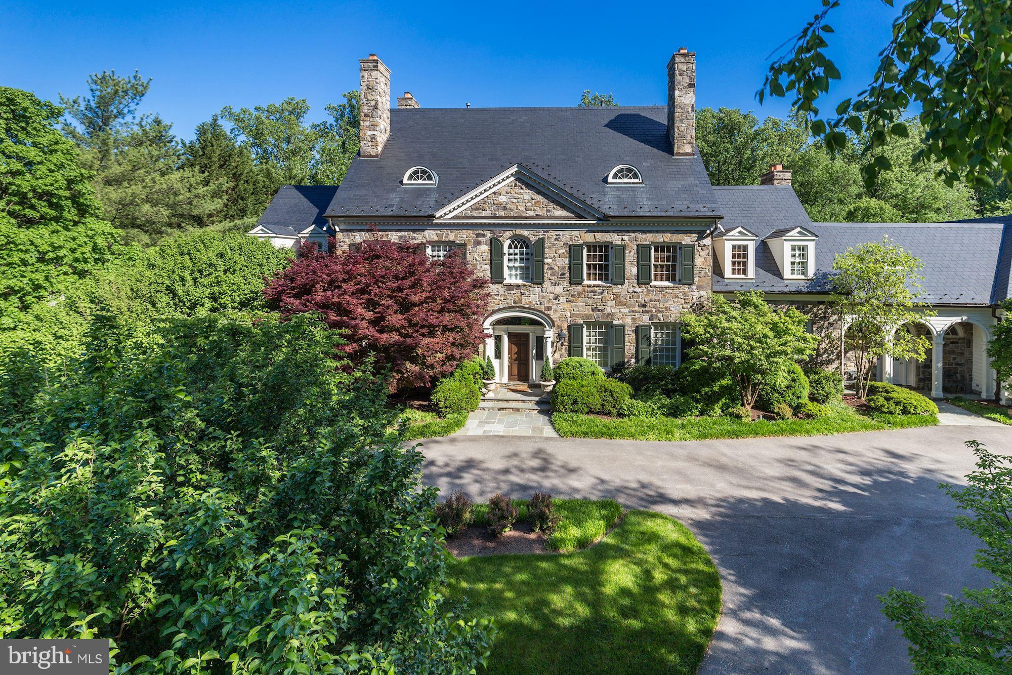 Impressive Colonial Estate on 2-acres of the desirable Country Club Dr bordering Congressional CC golf course. Circular Driveway w/ 5-car garage. Grand Scale Proportions w/ 10-ft ceilings and detailed moldings thruout. 6 Fireplaces. 7+BR, 8 Full + 3 HBAs including Main Lvl Suite. Walk-out LL w/ huge Wet Bar, Wine Cellar, Golf Rm. Expansive Rear Garden w/ huge stone terrace, fountain, & more!