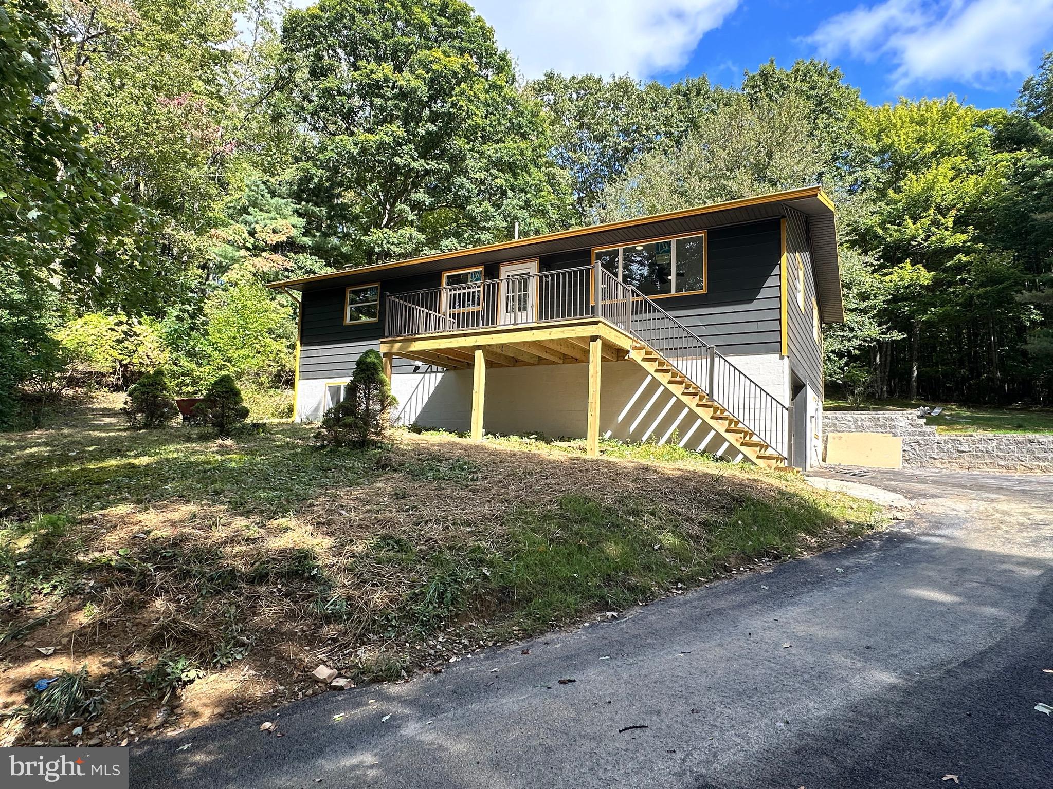 This stunning home sitting on top of Backbone Mountain has been completely gutted and remodeled with a modern and sophisticated look! The 4 bedroom 1 1/2-bathroom open concept home features a brand-new metal roof, front and rear deck, fresh paint inside and outside as well as new LVP flooring throughout.  The kitchen has new cabinets with quartz countertops with matching faucet and light fixtures. There are ceiling fans in all bedrooms. The one car garage has a new automatic garage door.  It has a new HVAC/CAC system, brand new plumbing, hot water tank and water softener.  It features 200 amp electric. 
The perfect home on 1.09 acres is waiting for you to be its new owner.