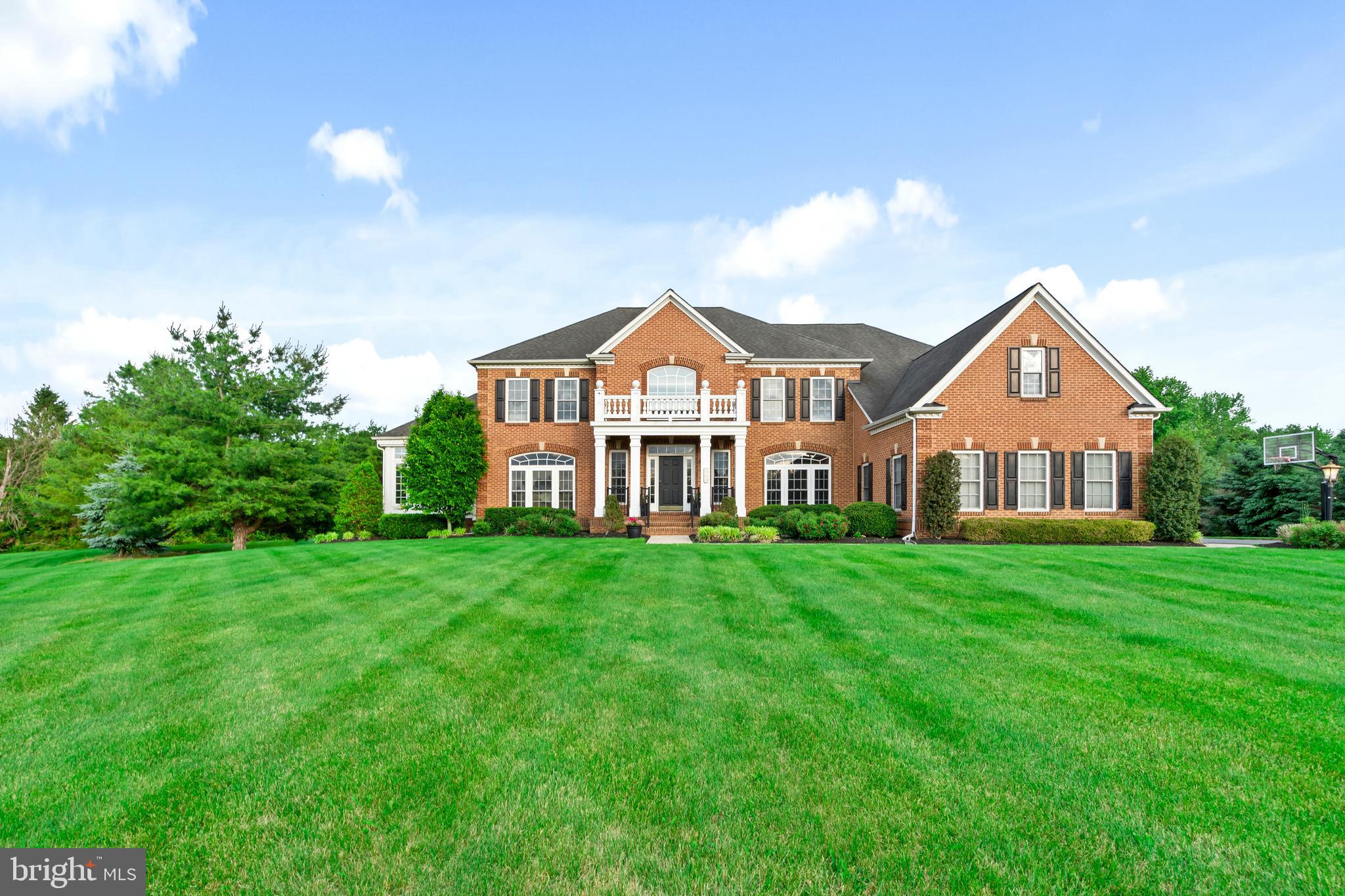 Welcome to one of the most exceptional properties in Warner Meadows, one of Newtown's most sought-after communities. Perfectly positioned on a private and beautifully landscaped 2.2-acre lot, this magnificent estate offers over 8,400 square feet of luxurious living space designed for both everyday comfort and grand entertaining. Featuring 5 spacious bedrooms and 6.5 bathrooms, every bedroom includes its own private ensuite bath, providing the ultimate in convenience and privacy. The thoughtfully designed open-concept floor plan is filled with natural light and showcases stunning views from the expansive family room through oversized windows that bring the outdoors in. The home has a large 3 car garage and plenty of space for additional parking. The main level offers a private executive office, formal living and dining rooms, a spacious game room, and a spectacular eat-in sunroom overlooking the rear grounds. The gourmet kitchen serves as the heart of the home, seamlessly connecting to the home's inviting gathering spaces. The fully finished walk-out lower level expands the living area with a bedroom, full bathroom, kitchenette, wine cellar, and abundant space for recreation, guests, or multi-generational living. Step outside to experience a true resort-style setting. Multiple terraces overlook the meticulously maintained grounds, highlighted by a stunning saltwater pool and a fully equipped pool house. Exceptional landscaping and outstanding curb appeal create a picturesque setting from every angle. Solar panels provide energy efficiency and help reduce utility costs. Located within the highly acclaimed Council Rock School District, this extraordinary property offers the perfect balance of privacy and convenience. Enjoy easy access to Newtown's charming restaurants, boutique shopping, parks, and nightlife, while being just a short drive from the vibrant destinations of New Hope and Doylestown. This is a rare opportunity to own one of the premier homes and most desirable lots in all of Warner Meadows.