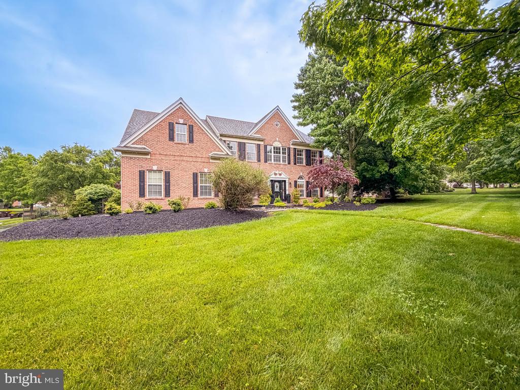 Welcome to 128 Wentworth Drive, nestled in the highly sought-after Holly Manor development in Montgomery Township. Stunning curb appeal and a handsome brick-front exterior welcome you into this sun-filled, expansive home featuring 4 bedrooms and 3.5 baths. The main level offers a flowing floor plan beginning with a dramatic two-story foyer, flanked by a spacious formal living room and elegant formal dining room, both enhanced by crown molding. The beautifully renovated gourmet kitchen is truly the heart of the home, boasting granite countertops, a ceramic subway tile backsplash, farm apron sink, center island with seating, pendant lighting, 42-inch cabinetry, top-of-the-line stainless steel appliances, a built-in desk area, and a bright breakfast nook with sliding doors leading to the backyard.  Adjacent to the kitchen is the impressive two-story family room, featuring a cozy wood-burning fireplace with slate surround, oversized windows, and skylights that flood the space with natural light. Also on the main level are a spacious home office, powder room, convenient laundry room with cabinetry, and direct access to the attached two-car garage. Upstairs, the gracious owner’s suite offers vaulted ceilings, three walk-in closets, and a fully remodeled en-suite bath with dual vanities, a soaking tub, and separate stall shower. Three additional generously sized bedrooms, each with ample closet space, and a well-appointed hall bath complete the upper level. The finished basement offers endless possibilities, featuring a wet bar, expansive open entertaining area, and a separate room with glass-paned French doors—ideal for a media room, game room, home gym, or additional office. Step outside to your own private backyard oasis, designed for entertaining, complete with a paver patio, in-ground pool, and inviting gazebo. This exceptional property offers the perfect setting for both everyday living and memorable gatherings with family and friends. Ideally located near shopping and conveniences including Costco, BJ's Wholesale Club, Wegmans, Trader Joe's, numerous fine restaurants, parks, train access, major routes, and Merck & Co., all within the award-winning North Penn School District.  Professional Photos To Follow - Don’t miss this rare opportunity.