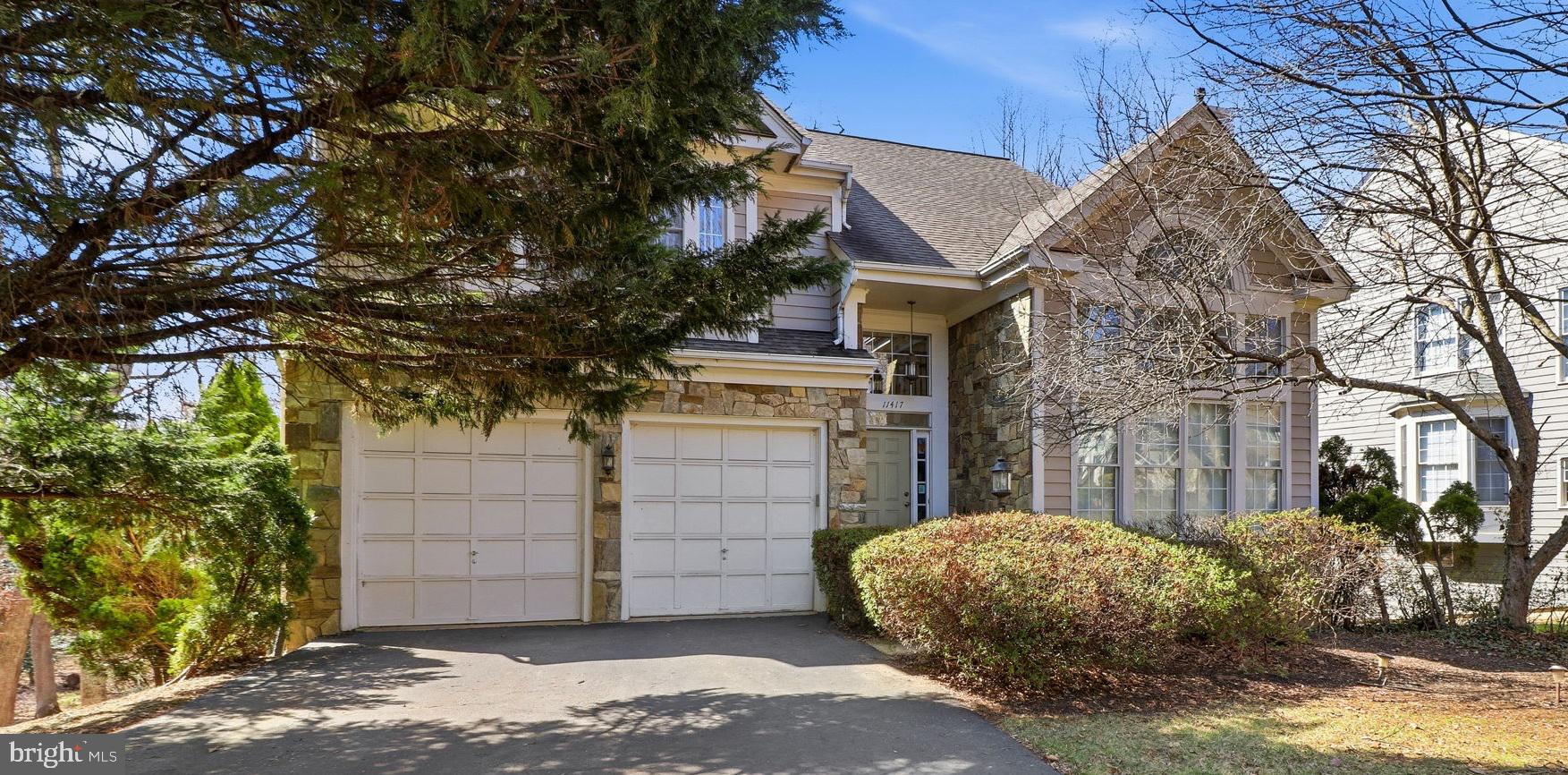 11417 Night Star Way offers a rare opportunity to own the desirable Austin model in coveted Wescott Woods of North Reston. Set back from the street, the home features excellent curb appeal with an attractive stone façade and numerous windows that fill the interior with natural light.  Upon entering, a dramatic two-story foyer and living room with a Palladian window create a bright, open feel. Hardwood floors run throughout the main level, including the kitchen and formal dining room. The home features two gas fireplaces and a beautiful sunroom with four skylights that open onto a spacious Trex deck. The property backs to a buffer of mature woods, offering a private and peaceful setting.  Upstairs are four bedrooms, two full baths, and a convenient laundry room. The spacious primary suite features two walk-in closets and a luxury en-suite bath with a separate tub and shower, two skylights, and views of the wooded backyard. The walk-out lower level is especially impressive with 10-foot ceilings, large windows, and a patio door that leads directly to a generous stone patio. This level also includes a wet bar, full bath, optional fifth bedroom (sitting above grade with egress windows), and a large storage room—making it ideal for an in-law suite or guest space. It is also roughed-in for an additional washer and dryer. This home was meticulously maintained by the original owner; the home features two-zoned systems with gas heat on the main and lower levels and a heat pump on the second floor. The kitchen is plumbed for gas but currently has electric appliances. Recent updates include a new roof (2019), gas furnace (2023), washer and dryer (2021), hot water heater (2018), and brand-new built-in microwave.  The home is being sold as-is. Dining room chandelier and curtain valances do not convey.