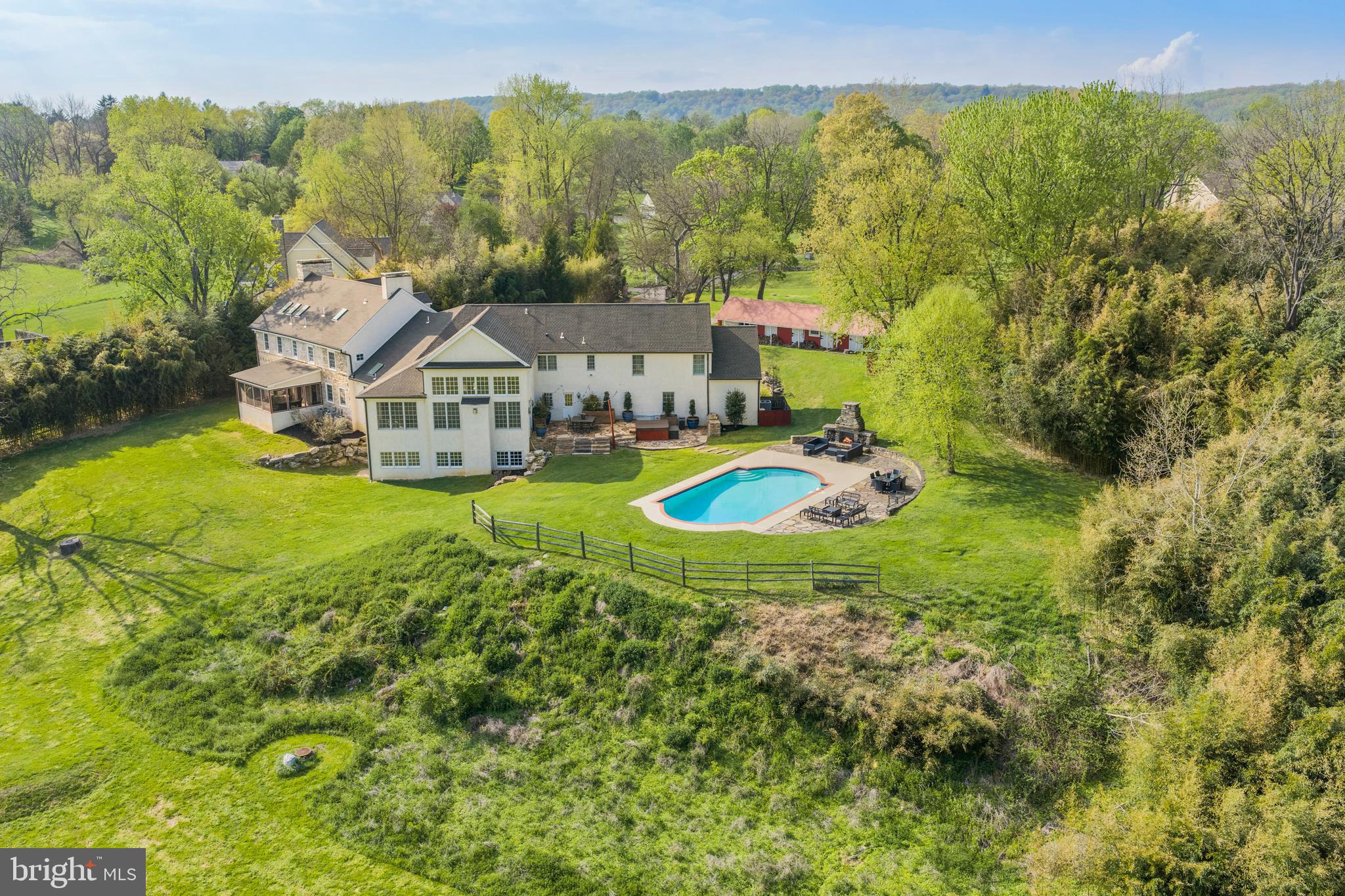 Poised at the end of a picturesque, tree-lined lane, 1660 Hidden Way offers a rare opportunity to own a home where timeless character and modern living exist in perfect harmony—set within the highly sought-after Tredyffrin-Easttown School District. The original section of the home dates to the 1760's and has been known as The "Original" Wilson Homestead (with the property including the tract of land now known as Wilson Farm Park in Chesterbrook).  A stone addition was constructed in the 1800's with a newer wing nearly doubled the size of the home in 2008.  From the moment you arrive, you’ll appreciate the home’s history and architectural details—rich hardwood floors, original period millwork, numerous fireplaces, and beautifully exposed original stone walls featured throughout multiple rooms, reflecting exceptional craftsmanship and enduring quality. These historic elements are seamlessly complemented by expansive, light-filled living spaces designed for both everyday comfort and effortless entertaining. This impressive residence features 5 spacious Bedrooms, 4 full Baths, 2 half Baths, a finished walk out Lower Level and a 4 car Garage. First Floor includes a 2 story Great Room, Kitchen with Breakfast Room, Fireside Dining Room, Den with a wood buring fireplace, original Living Room showcasing 2 fireplaces, a screened-in porch, a full Bathroom and a Powder Room. Two separate staircases lead one upstairs to discover the impressive Primary Suite with renovated Bath and oversized walk in closets, Laundry Room, Office, 3 additional Bedrooms (2 with exposed stone walls) and 2 full Bathrooms. The Third Floor offers the 5th spacious Bedroom which could also make a wonderful playroom or private bonus space. The Lower Level features generous finished space with a half bath. windows, a walk out doorway and considerable unfinished storage space. Set on over 7 breathtaking acres, the property showcases gorgeous, panoramic views in every direction. A lovely, meandering stream with a  pond add to the storybook setting and enhances the natural beauty that surrounds the home. The sparkling pool provides the perfect centerpiece for summer relaxation and entertaining while the adjacent stone fireplace takes the chill off during the cooler evenings. A charming red stable was once home to horses and livestock. Blending old-world charm with modern space and amenities, this exceptional property delivers a lifestyle of comfort, elegance, and tranquility.  Deemed to be of "Historical Importance" in Tredyffrin Township, one can appreciate the property's prominent history.  With terrific proximity to wonderful shopping, dining, the Paoli Amtrak train, rt 202, other major arteries and the Phila Int'l Airport, commuting is a breeze from this ideal location. 1660 Hidden Way is more than a home—it’s a unique and remarkable retreat. Schedule your tour today!