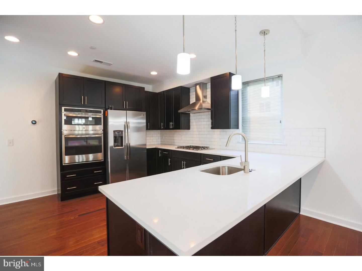 This newer construction townhouse (built in 2016) is located along the Frankford Arts Corridor, known for its special boutiques, cafes, and acclaimed food and social venues. The townhouse is part of Fishtown Residence Development which offers an opportunity to immerse yourself in everything that this thriving community has to offer. Property offers 3 bedrooms, 2   bath, Flex space, living room, dinning area, spread over 2600 square feet of modern living space. The kitchen comes equipped with stainless steel appliances - gas range stove, microwave, and dishwasher, refrigerator with water and ice dispenser - double sink with garbage disposal, quartz counter top and a tile backslash with modern twist. Large window in the kitchen. All three bedrooms are large and each have built-in closets making this ideal for roommates, a family or anyone who desires some extra space. Roof top deck with incredible city views.  Secure Gated Parking (2 spots in the back of the house, large enough to fit 3 compact cars). Stunning kitchen with quartz counter top and all brand new energy efficient appliances. Hardwood floors throughout the whole house. Inquire quickly! We welcome your visit today!