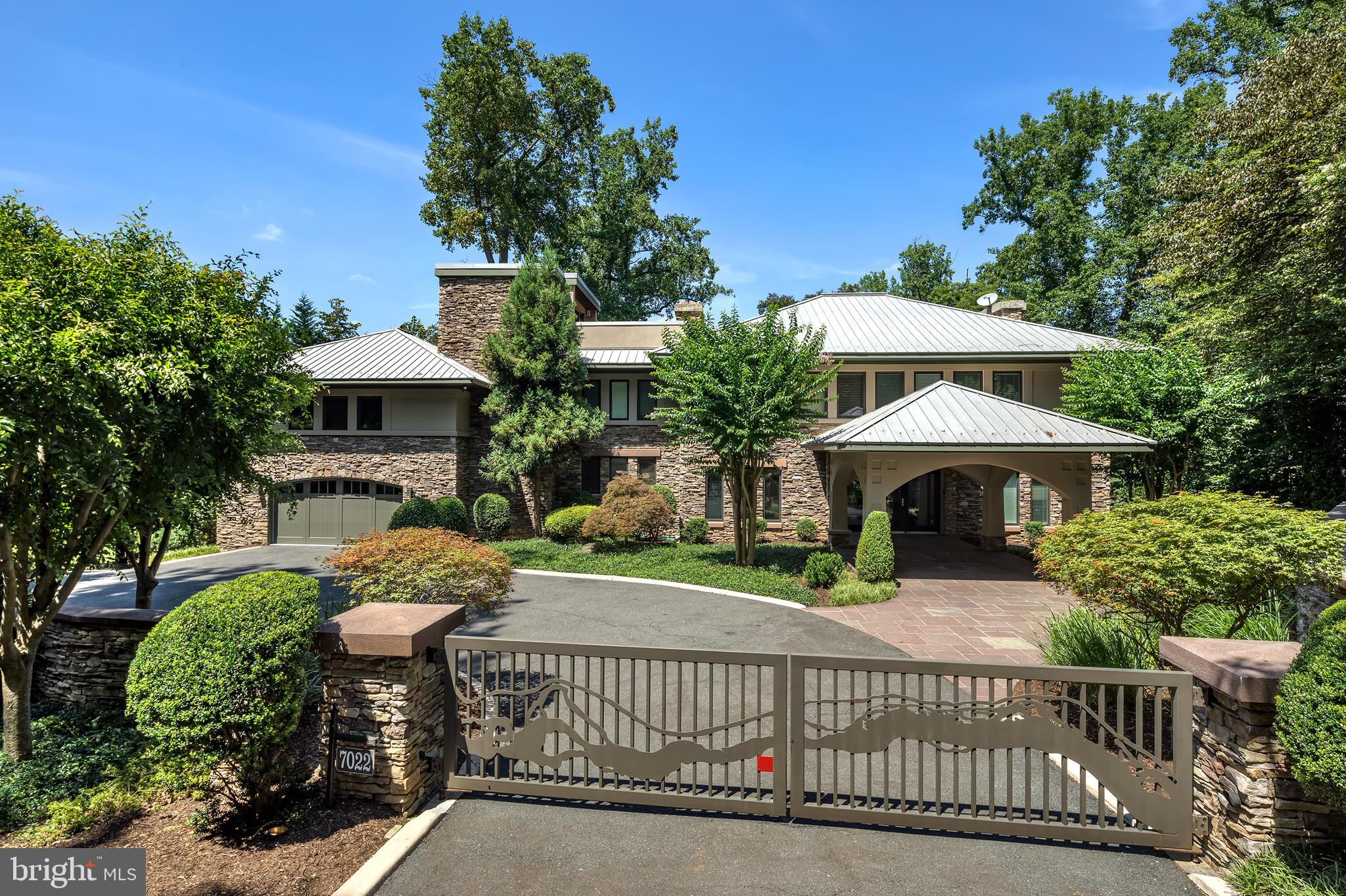 MOVE-IN READY WITH ALL FF&E TO CONVEY, IF REQUESTED.  PERFECT FOR THE TRANSIENT BUYER!  
Custom-built waterfront estate situated on the Potomac River along the Gold Coast of Mclean and  Scotts Run with awe-inspiring views, unparalleled privacy, as well as close proximity to nature and culture.  Perfect for the  Life at Green Oak on the Potomac offers an experience like no other. Reflecting timeless modern architecture designed by Robert Wilson Mobley, the stone and stucco of Green Oak blend seamlessly with the 5 acre verdant wooded landscape atop a 62-foot stretch of private waterfront property that features true river access for outdoor aficionados. 
Inside, attention to detail and thoughtful design on all five levels create a custom built ambiance that affords residents a rare sense of sophistication and serenity. Overlooking the great room from the interior balcony, the owner’s suite provides a harmonious getaway and bird’s eye view with ultimate privacy, his and her dressing rooms, fireplace and secluded library. Three secondary bedrooms all feature exquisite fireplaces, walk-in closets, and full bathrooms. With two elevators located on the east and west wing, Green Oak showcases an upper-level entertainment room, bar, and media center as well as convenient access to the roof level sitting area and outdoor observation deck and fireplace. For wine connoisseurs, the 1,000-bottle capacity custom wine cellar offers a space to ensure that fine wines can retain value and even develop a more complex flavor and aroma over time. To fully enjoy the Green Oak lifestyle, one must experience the spa level’s Finlandia sauna, indoor Endless Pool, and outdoorsman suite including a secure firearms safe and fly rod room. Living at Green Oak is a dream come true for fishing, kayaking, canoeing, swimming, boating, hiking, and birdwatching the more than 150 species of bird that make the Potomac River watershed home. Not only a nature lover’s paradise, Green Oak is also equidistant to both Reagan and Dulles International Airports, 15 minutes to Georgetown and less than 15 miles from world renowned museums, theaters, and shopping in the Nation’s capital.