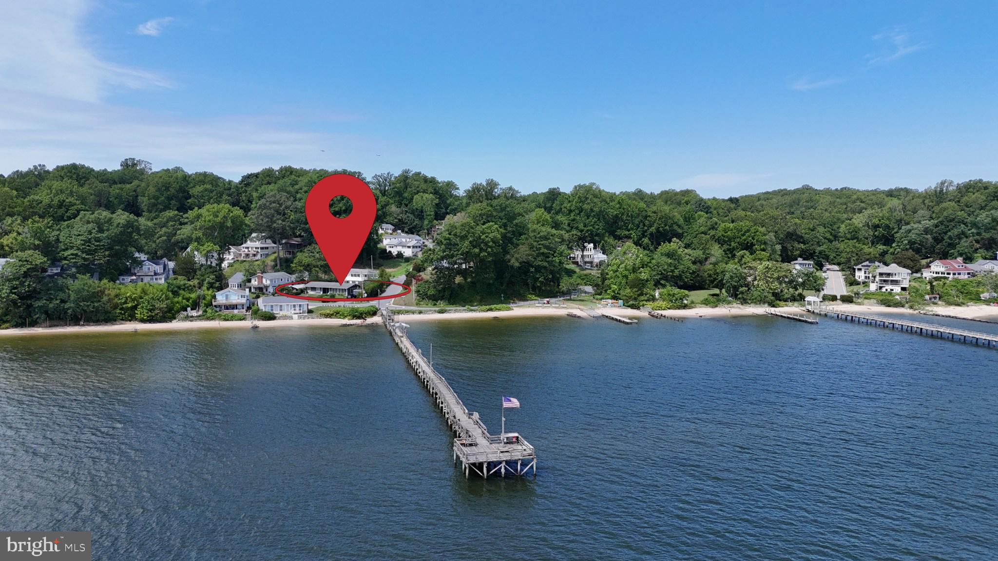 Wake up to Chesapeake Bay views and spend your days enjoying one of Calvert County's best-kept secrets. This beautifully renovated non-riparian waterfront home sits directly across the street from a long community beach and private community pier, just steps from your front door. Whether you're launching a kayak, fishing from the pier, searching for fossils along the shoreline, or simply taking in the Bay breeze, the waterfront lifestyle is always within reach.

Thoughtfully renovated inside and out, this home blends modern comfort with the character and charm that make Chesapeake Bay cottages so special. Original architectural details have been preserved and incorporated into the design, creating a warm coastal atmosphere that feels both timeless and inviting. The updated kitchen, baths, finishes, and systems allow you to move right in and start enjoying life by the water.

Outdoor living takes center stage here. Gather with family and friends on the expansive terrace beneath the pergola, enjoy fresh Maryland crabs at the all-weather bar, soak in the hot tub while watching the sunset over the Chesapeake Bay, or simply relax and listen to the sounds of the water. Every space has been designed to make the most of this exceptional setting.

With multiple bedrooms, including a fun bunk room that comfortably welcomes the whole family, there is room for everyone to enjoy. Some furnishings and décor may convey, making this an easy transition for buyers seeking a turnkey coastal retreat.

Perfect as a primary residence, weekend getaway, or investment property, this home offers the flexibility today's buyers are looking for. Short-term rentals are permitted, creating an opportunity for personal enjoyment and income potential when you're not using the property yourself.
Dues are $150 a year; they are optional but provide access to the pier. There are a variety of community events throughout the year. 
Come experience the Chesapeake Bay lifestyle, where the beach, pier, sunsets, and water are part of everyday life. This is more than a home. It's a place to make memories for years to come.