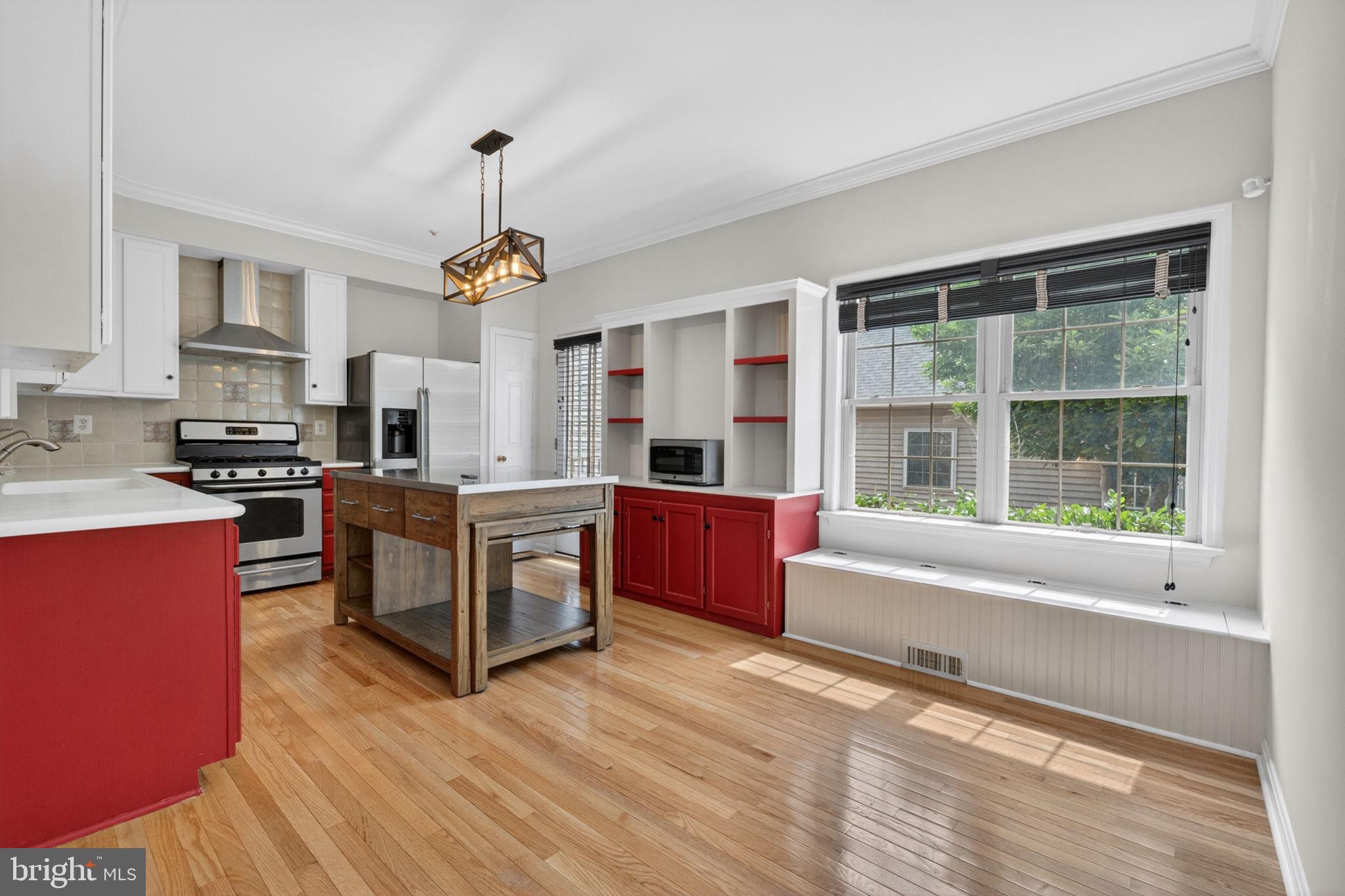 Welcome to this beautifully updated townhouse in the highly sought-after Worman's Mill community, where thoughtful upgrades and timeless architecture come together in a home that truly stands apart. From the moment you step inside, the character is unmistakable. Hardwood floors flow throughout the main and upper levels, leading you into a sun-drenched living room anchored by a stunning floor-to-ceiling bay window and an elegant curved archway. The kitchen continues to impress with Corian countertops, stainless steel appliances, a center island with a stainless steel top, and a charming window seat perfect for morning coffee or a casual meal. The finished lower level offers two generously sized flex rooms, ideal for a home office, gym, or guest space. One features a cozy gas fireplace, making it a natural gathering spot in the cooler months. Smart home upgrades, including a smart thermostat, Brink's alarm system, camera doorbell, and a Culligan Smart Soft Water System, add everyday ease and peace of mind. Custom wood blinds and new light fixtures (2026) give every room a polished, move-in-ready feel.
Outside, a brand-new deck and patio (2024) set the stage for entertaining or quiet evenings in a private, fenced yard. A detached two-car garage with workbench and additional storage rounds out the exceptional functionality of this home. And when you're ready to head out, you're steps from Plaza Mexico and minutes from Wegmans, Walmart, Marshalls, and OneLife Fitness.