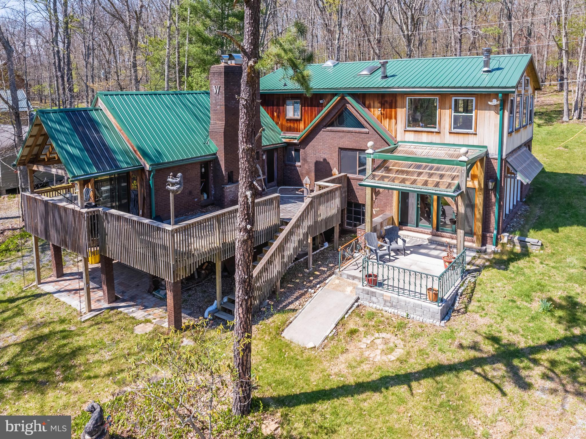 Custom built by the original owners and thoughtfully expanded with a recent addition, this exceptional five-bedroom, 3.5-bath home is set on 100 feet of split lakefront in desirable Penn Cove. Featuring a coveted Type A dock permit, lakeside fire pit and pavilion, and easy shoreline access, the property is designed to embrace lake living in every season. Set on a generously sized lot with abundant parking, oversized multi-car garage with interior access, usable backyard, wooded walking paths, and nearby UTV and snowmobile trails, the setting offers a rare balance of privacy and recreation. Inside, natural light fills the home, where hardwood floors, cathedral ceilings, wood-burning fireplaces, and open-concept living spaces create warmth and character. A flexible layout with multiple living areas offers room for gathering, multi-generational living, or separate guest quarters, with potential for vacation rental use. Minutes from Pawn Run, downtown Oakland, and a short drive or boat ride to Wisp Resort, restaurants, and shopping, this is a rare opportunity to own a legacy property designed for making memories for generations.