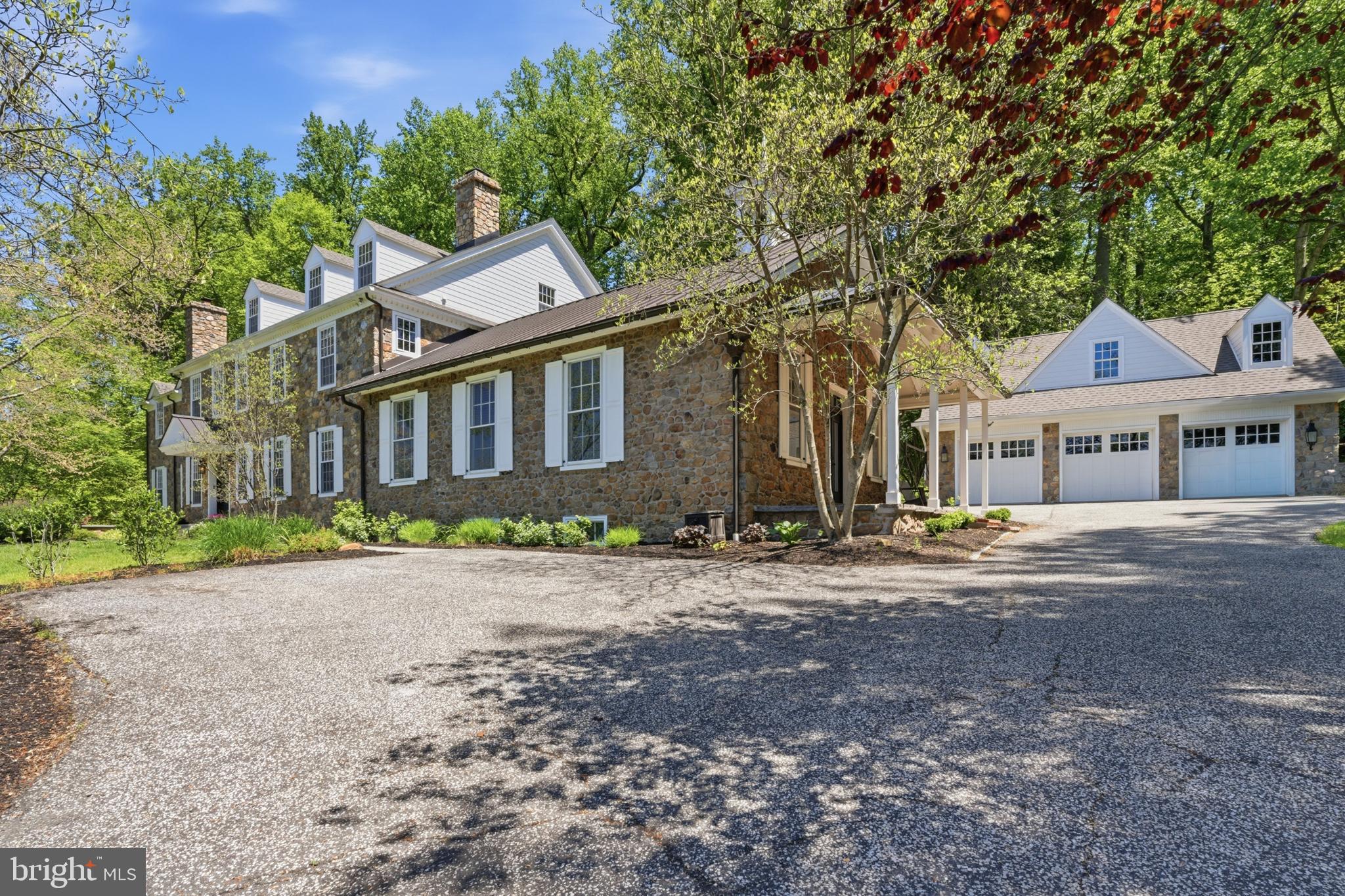 A once in a lifetime opportunity to own a piece of Willistown history & one of the most custom built homes you'll ever see!  Welcome to Shady Grove School House, ca 1850, named after the large white oak trees nearby.  This one room schoolhouse stands proudly on a gorgeous 1.6 acre with a custom home attached built in 2001, creating a one of a kind 7,500+ square foot home which the current owners have done an unbelievable job renovating.  The level of detail throughout doesn't resonate until you see it in person.  The best materials used throughout, unlacquered brass door knobs, Hardie siding, Tuscan Versilia marble are just to name a few.  The home is perfectly perched offering stunning views from every window, with preserved land across the street.  The beautiful flow, bringing the outdoors in with it's many access points for enjoying the private Timbertech decks that hug the home.  Entertaining is a delight & each room flows seamlessly into the next with arched doorways, dental moldings & deep sills, perfectly replicating the original school house detail.  The bluestone walkway & circular patio out front greet you.  The 2 story center hall foyer is spectacular with natural light pouring in from all angles.  The main level provides an exceptional layout for ease of every day as well as the best entertaining layout possible.   Greet your guests in the foyer, utilize the schoolhouse space with it's high ceilings with wood beam detail,  reception room size & gorgeous stone fireplace.  The open concept kitchen, great room, butlers pantry & bar makes for a great holiday set up.  The kitchen design with perfectly curated materials & appliances makes it so special. Sub zero fridge/freezer, 2 paneled dishwashers, 48 inch wolf range, upgraded lighting, 2 tone inset cabinets, unlacquered brass hardware & large center island make it a show stopper.  The large great room with large fireplace/hearth has a beautiful lacquered bar with mirrored backsplash, sub zero wine fridge & 2 beverage drawers & built-in ice maker, allowing your guests to help themselves.  The formal dining room with dentil moldings & paneled walls & living room with a fireplace  are located off the entry foyer.  The first floor also offers a primary bedroom option with a large bedroom that has a new full bath with walk-in shower, walk-in closet, fireplace and built ins.  Also on the first floor is a large mudroom area, laundry room with cabinetry, washtub & plenty of counter space, a half bath for guests, the perfect butlers pantry with stunning wallpaper & a back staircase.  On the 2nd floor you'll find a large primary suite with a sitting room with it's own balconette, large bedroom with Carrera surround fireplace (double sided in the bed and large bath) & 2 walk-in closets.  Plenty of additional bedroom suites with full baths &  jack and jill's make the layout extremely versatile, depending on your needs.  Each room has large closets with plenty of space for larger furniture.  3rd floor offers a 7th bedroom option if needed & has been recently updated with plush carpeting, drywall & lighting.  Tons of attic storage space.  The basement of the home is unfinished, yet plumbing is easily accessible if you wanted to add more living space.  The systems have been updated & made more efficient to include 3 new AC units, 2 LED air purification, new furnaces, new hot water heater, whole house generator &  whole house surge protectors.  The 3 car detached garage offers a wide open loft space, just waiting to be finished into an office, studio or added living space.  Some other recent upgrades include new roofing, removal of stucco & the addition of Hardie, an electric fence, the careful rebuilding of the schoolhouse cupola, repointing of chimneys, new window, doors, gorgeous hardscape added, electric fence, light automation & much more!  You truly have to see this home in person to appreciate its beauty, flow, scale and quality.  The best of everything & one you can't' miss.